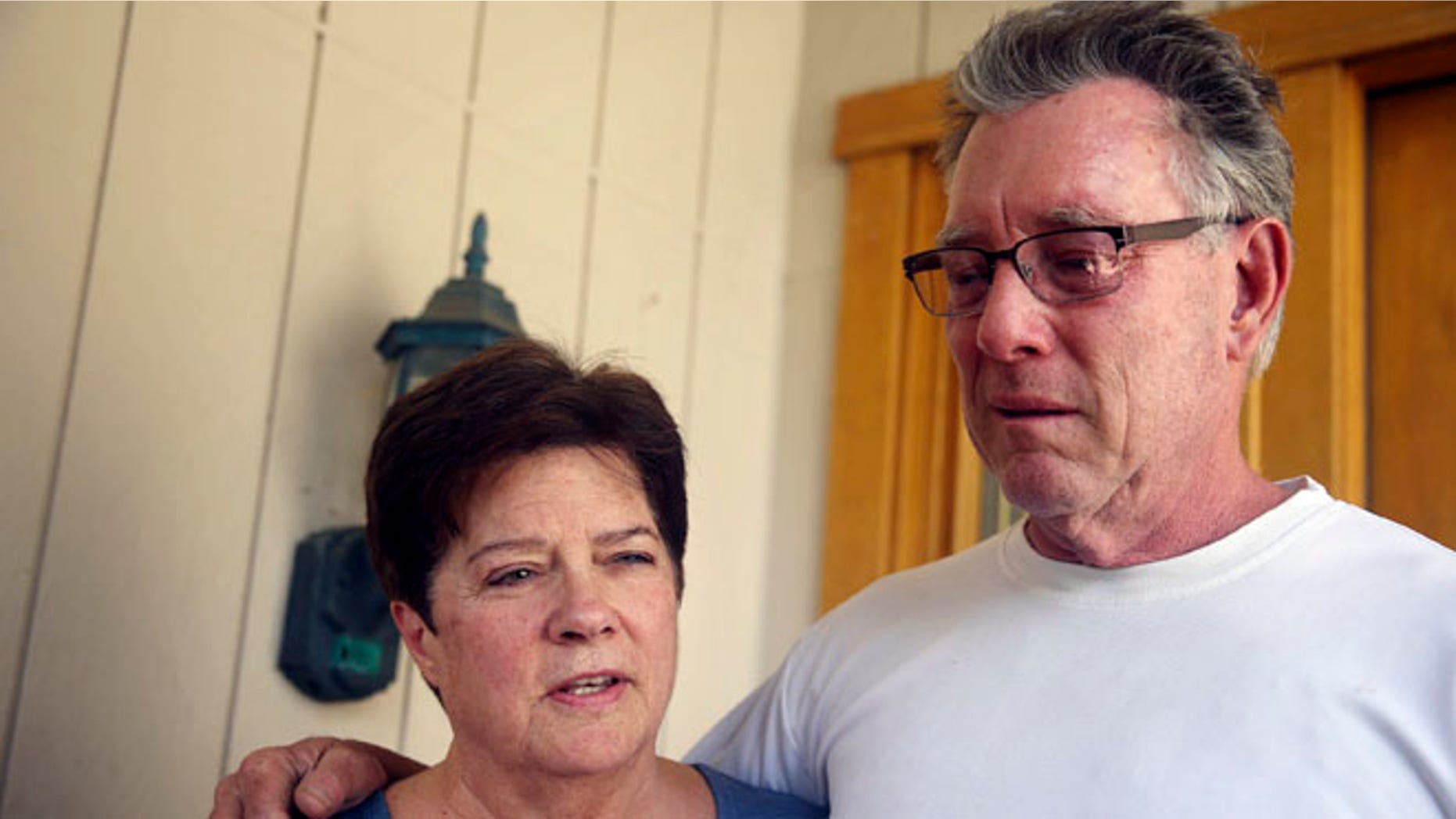 FILE -- July 2, 2015: Liz Sullivan, left, and Jim Steinle, right, parents of Kathryn "Kate" Steinle, talk to members of the media outside their home in Pleasanton, Calif.