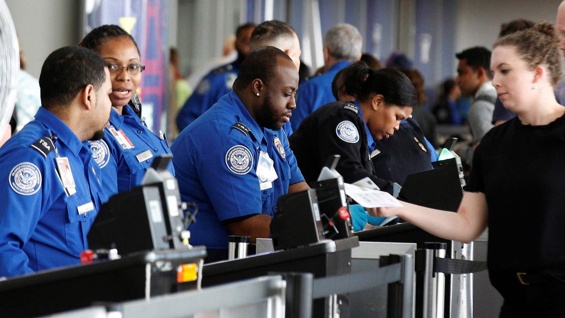 May 27, 2016: Transportation Security Administration (TSA) agents check-in passengers at JFK airport in the Queens borough of New York.