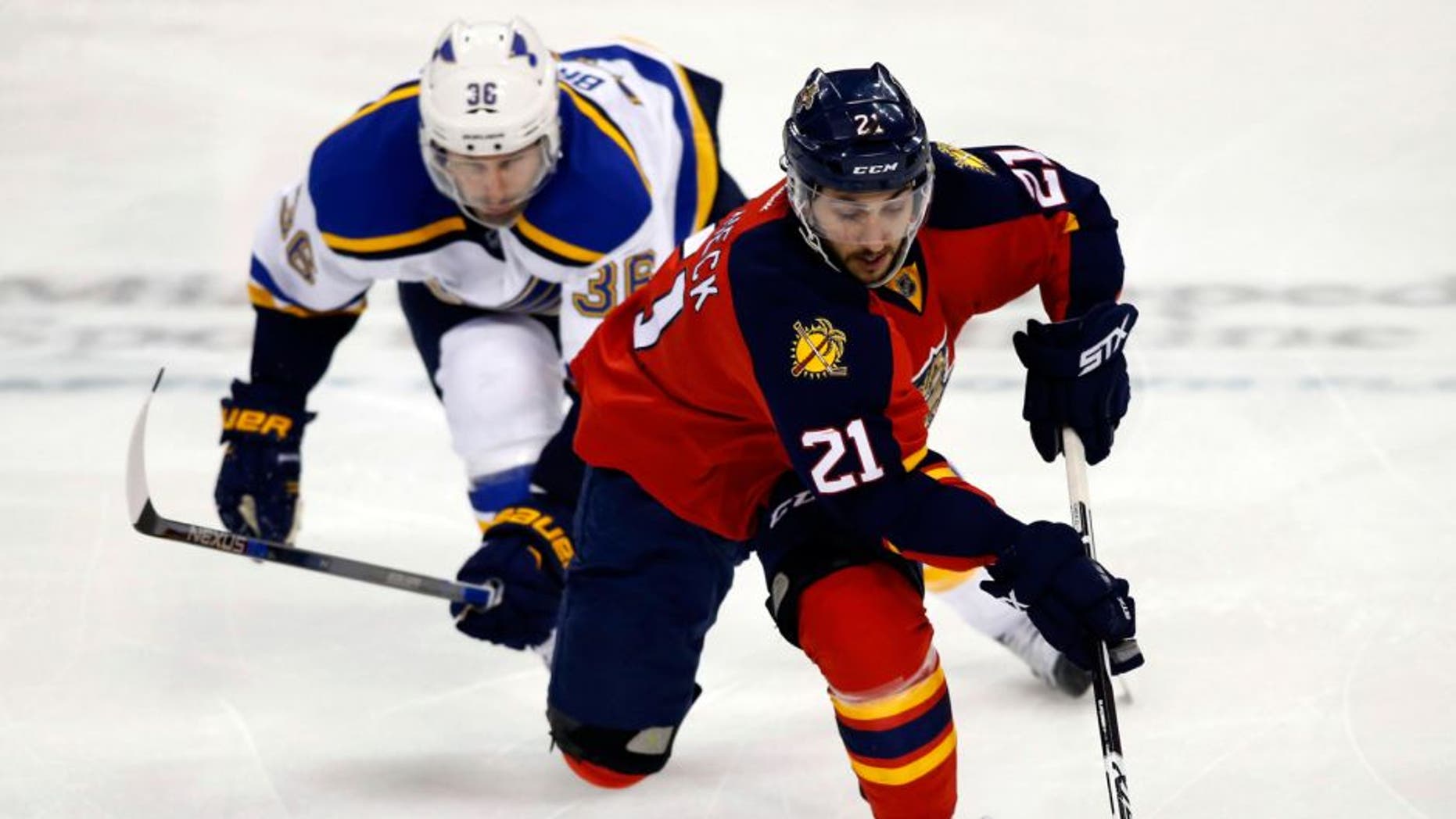 Feb 12, 2016; Sunrise, FL, USA; Florida Panthers center Vincent Trocheck (21) skates with the puck as St. Louis Blues right wing Troy Brouwer (36) pursues in the third period at BB&T Center. The Blues won 5-3. Mandatory Credit: Robert Mayer-USA TODAY Sports