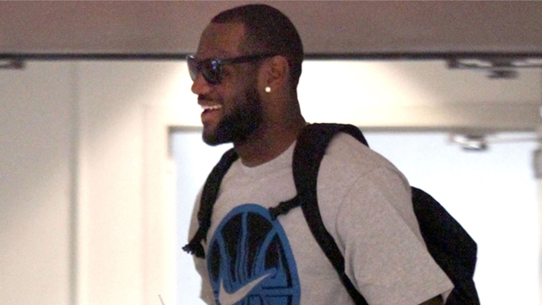 July 2: Free agent basketball player LeBron James makes his way through the IMG building to talk with the Miami Heat in Cleveland.