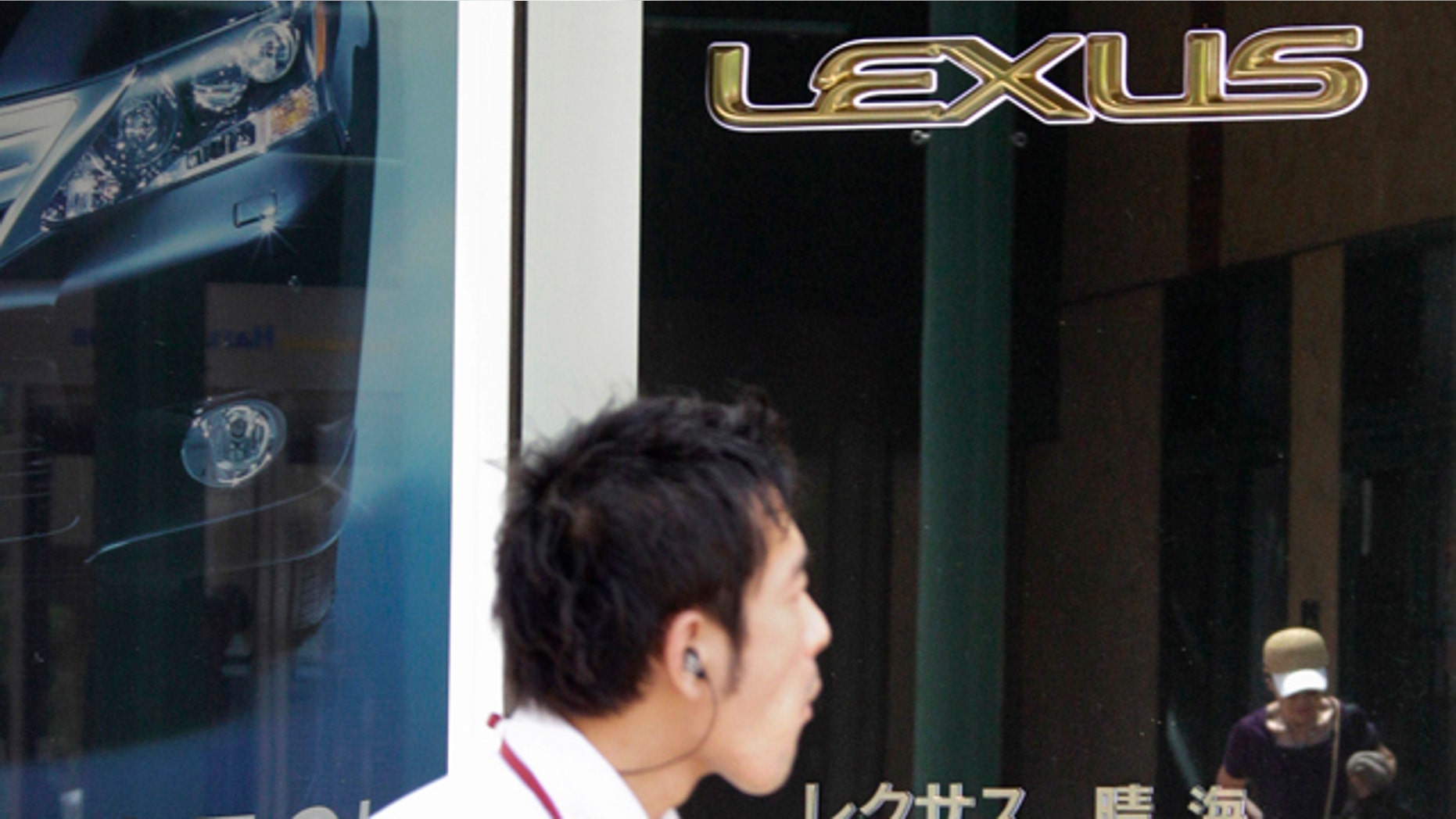 July 5: A man walks beneath the Lexus logo at a Toyota dealership in Tokyo.