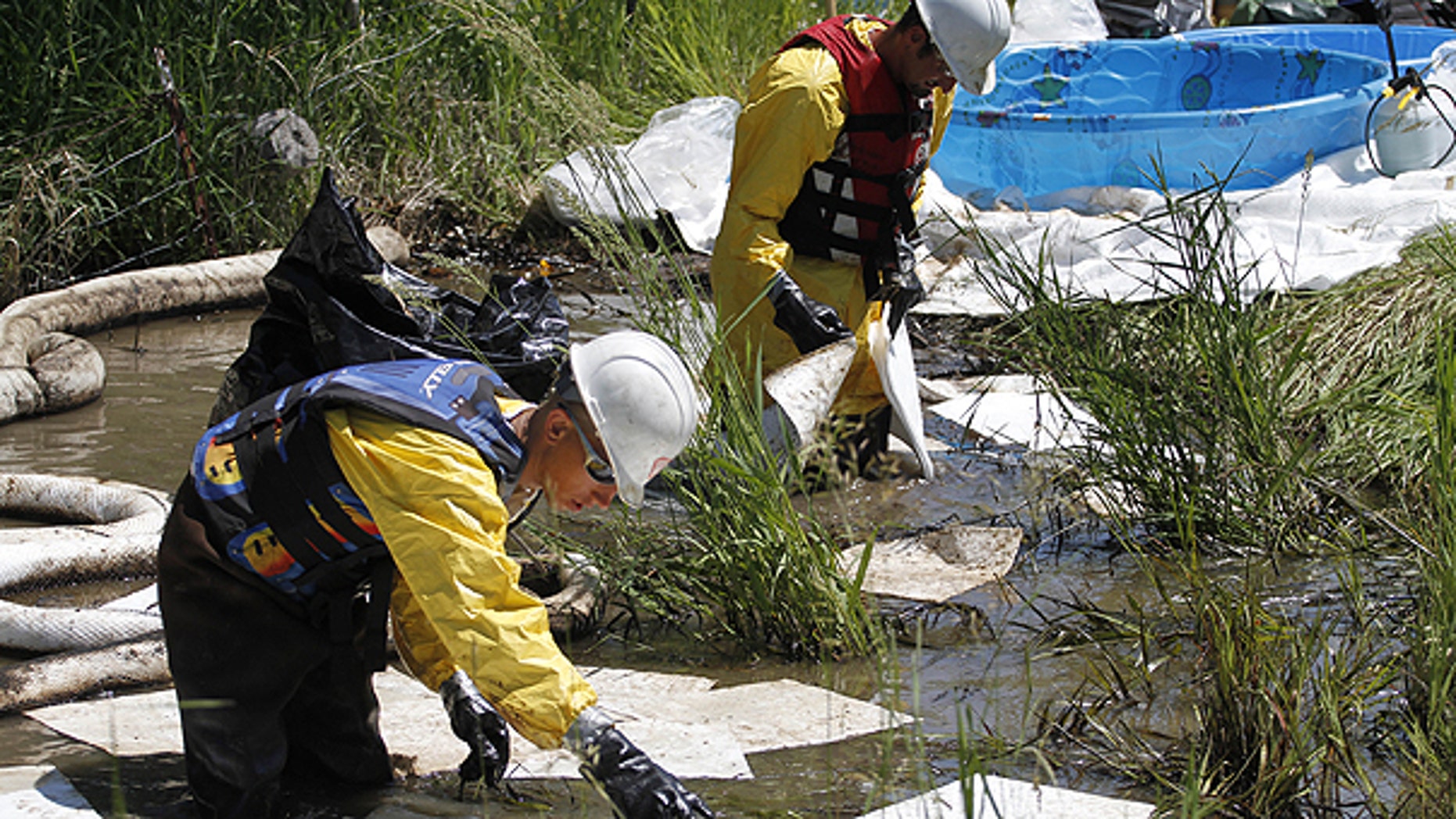 July 5: Cleanup crews work to clear oil from along side the Yellowstone River in Laurel, Mont.