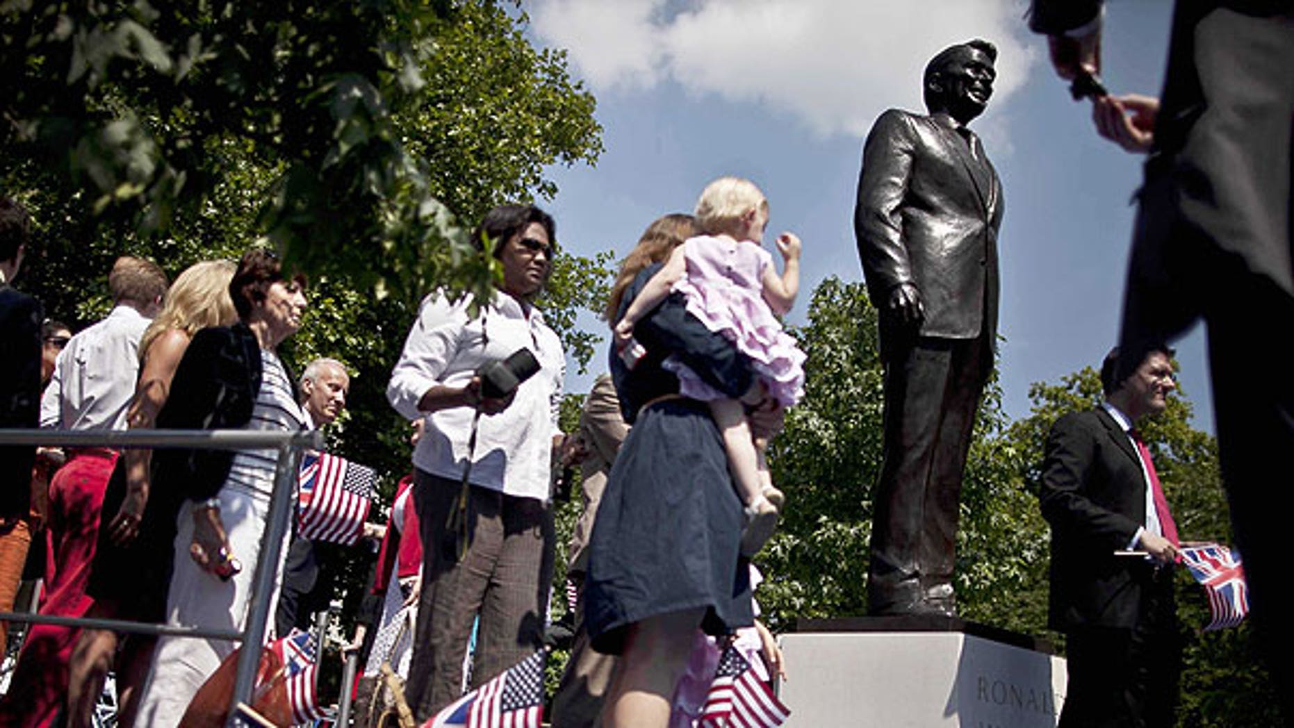 July 4: People take their turn to pose for photographs beside a statue of the late U.S. President Ronald Reagan after its unveiling outside the U.S. embassy in London.