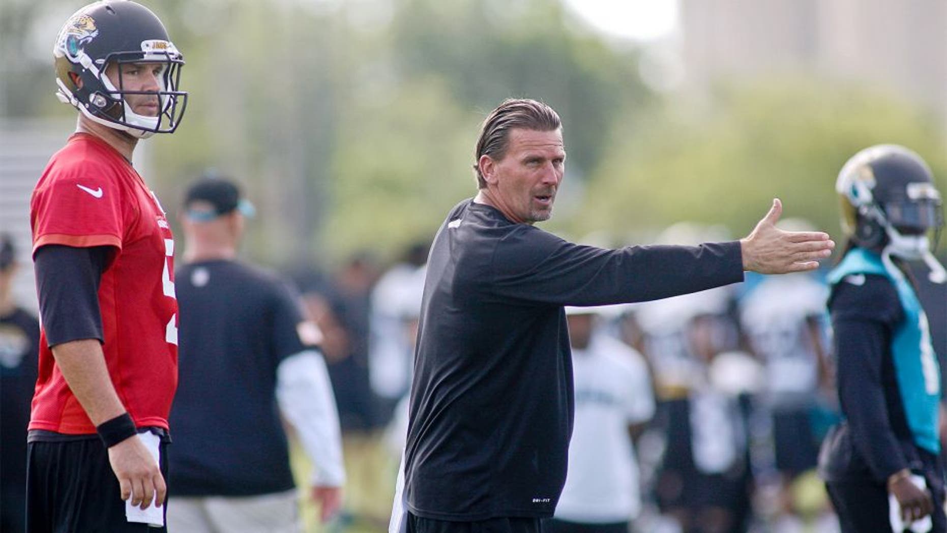 May 28, 2015; Jacksonville, FL, USA; Jacksonville Jaguars quarterback Blake Bortles (5) looks on as offensive coordinator Greg Olson gestures during OTAs at the Florida Blue Health and Wellness Practice Fields. Mandatory Credit: Phil Sears-USA TODAY Sports