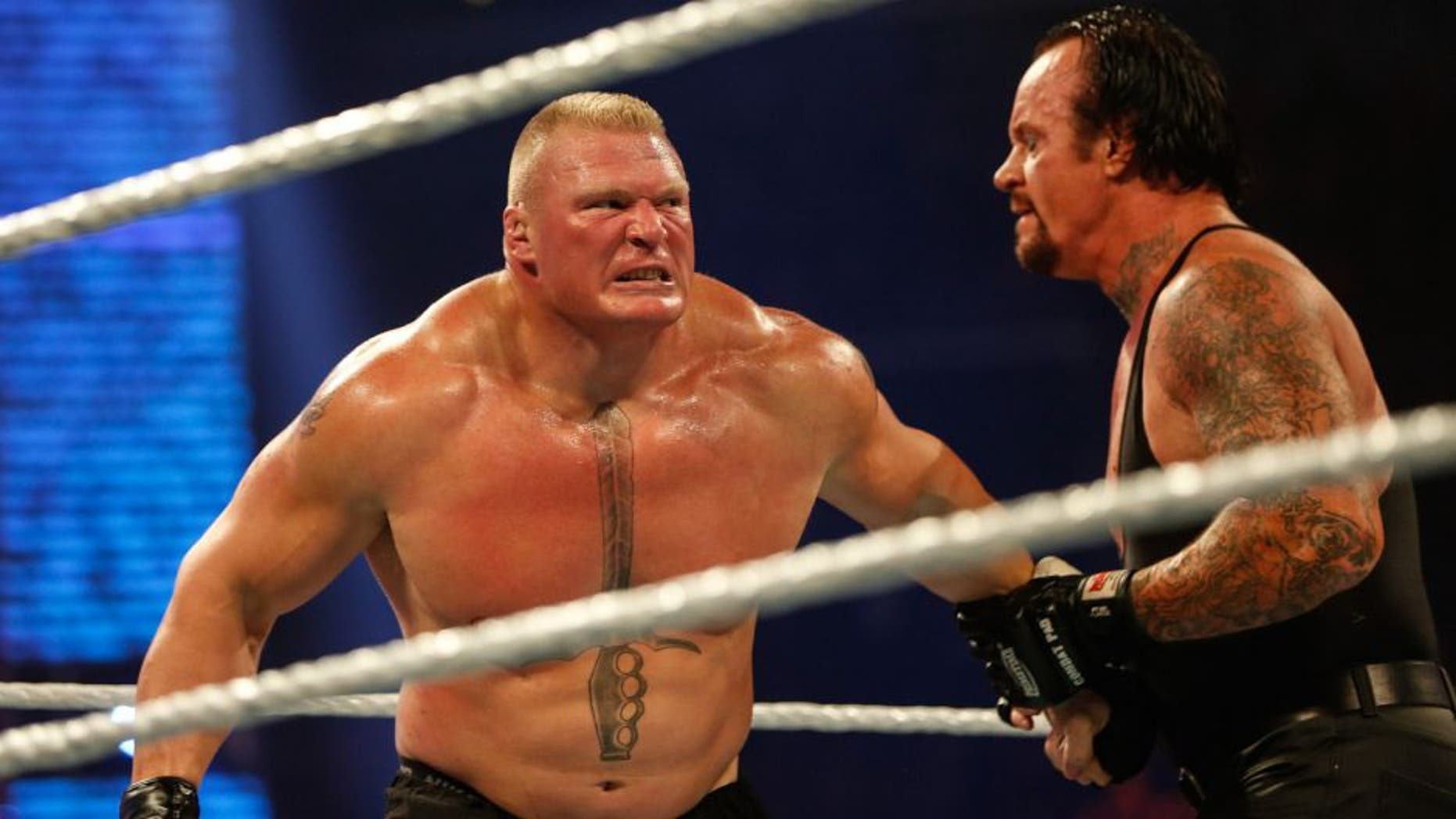 NEW YORK, NY - AUGUST 23: Brock Lesnar and The Undertaker battle it out at the WWE SummerSlam 2015 at Barclays Center of Brooklyn on August 23, 2015 in New York City. (Photo by JP Yim/Getty Images)