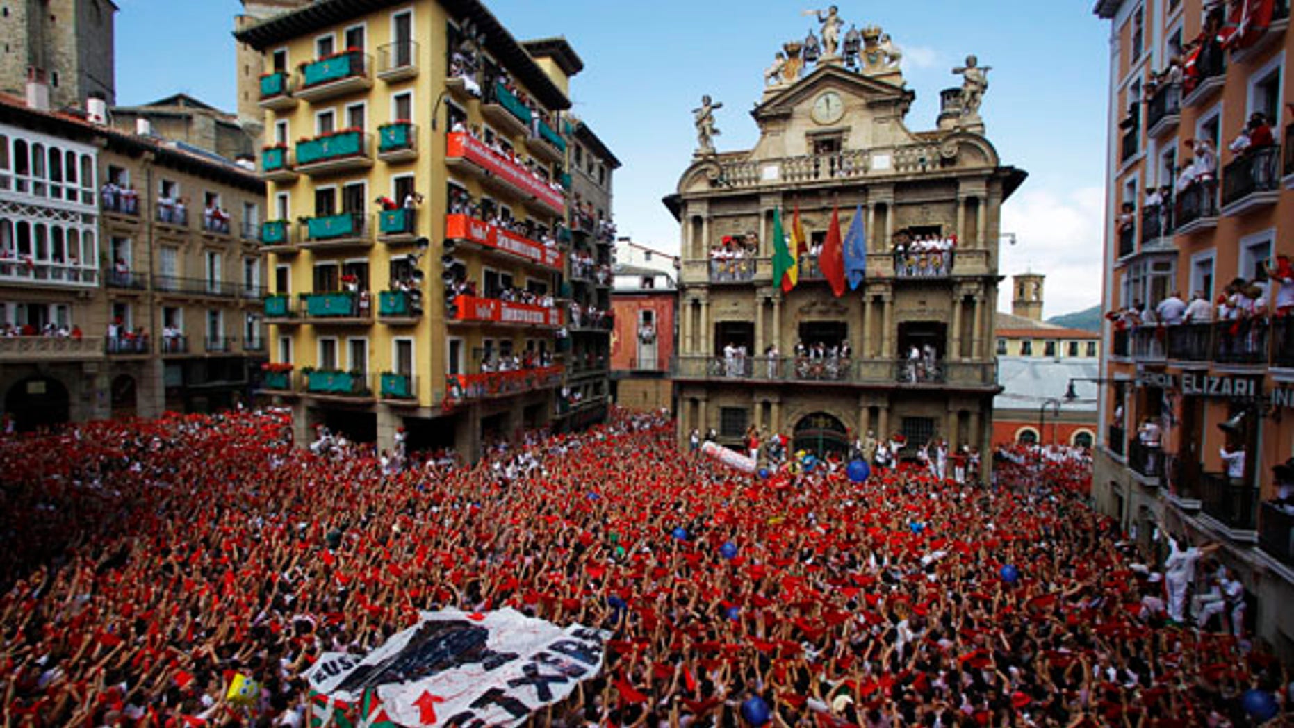 July 6: Revelers hold up traditional red neckties during the 'Chupinazo', the official opening of the 2010 San Fermin fiestas in Pamplona, Spain.