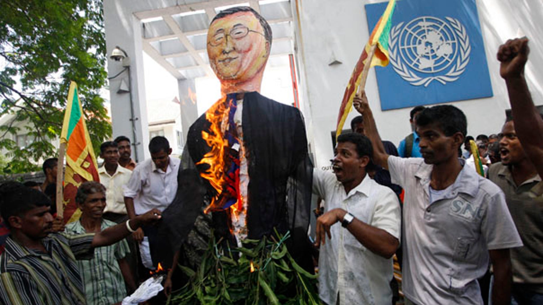July 6: Sri Lankan protesters wave their national flags and burn an effigy of U.N. Secretary General Ban Ki-moon outside the U.N. office in Colombo, Sri Lanka.