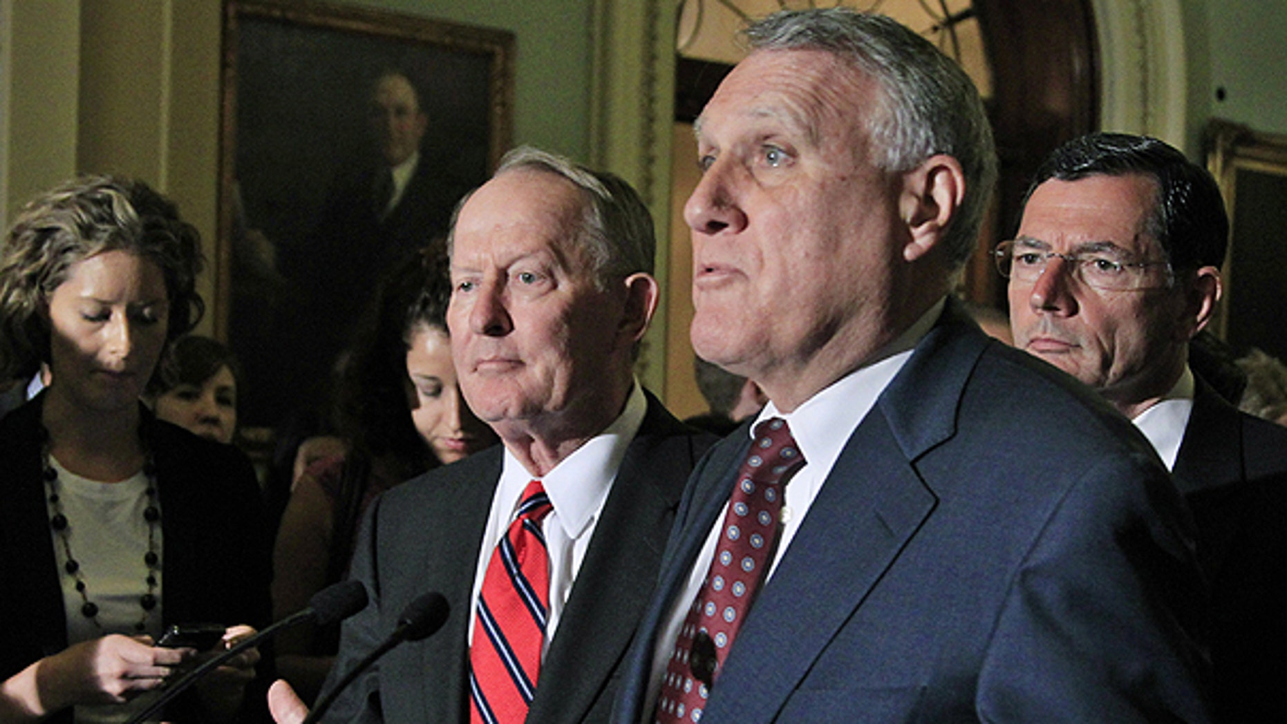 July 6: Senate Minority Whip Jon Kyl of Ariz., center, accompanied by Sen. Lamar Alexander, R-Tenn., left, and Sen. John Barrasso, R-Wyo., speaks on Capitol Hill in Washington.