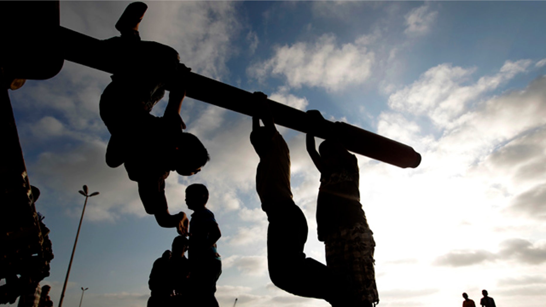 July 2: Libyan boys sit on the cannon of a destroyed army tank in the rebel-held Benghazi, Libya.