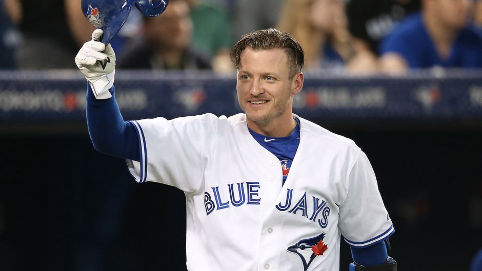 TORONTO, CANADA - JUNE 8: Josh Donaldson #20 of the Toronto Blue Jays greets a member of the Miami Marlins as he tips his helmet during MLB game action against the Miami Marlins on June 8, 2015 at Rogers Centre in Toronto, Ontario, Canada. (Photo by Tom Szczerbowski/Getty Images)