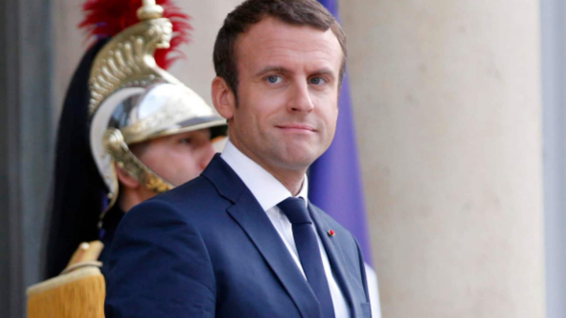 France's President Emmanuel Macron waits prior to welcoming Mexico's President Enrique Pena Nieto, for a dinner at the Elysee Palace, in Paris, Thursday, July 6, 2017.