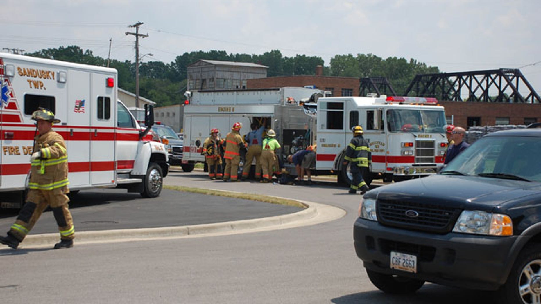 July 7: Emergency personnel unpack equipment from their vehicle at the site of a roof collapse at a factory on Front Street in Fremont, Ohio.