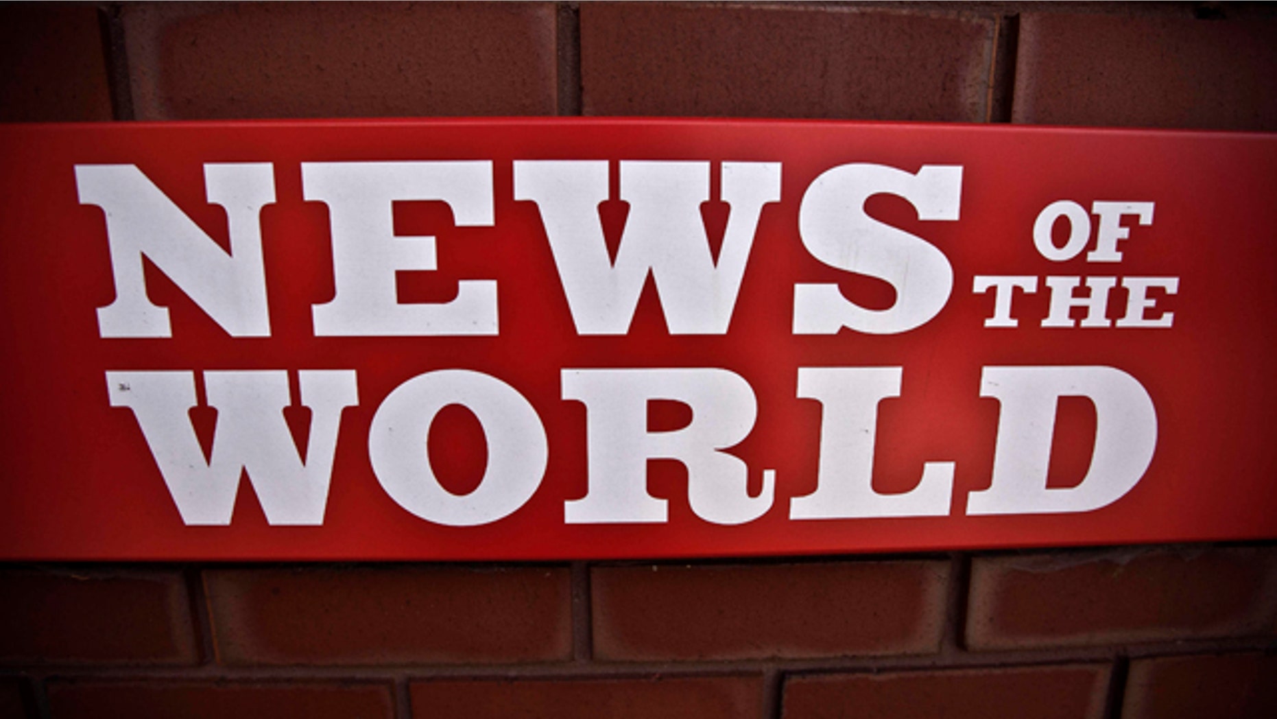 July 6: News of the World sign is seen by an entrance at premises of News International in London.