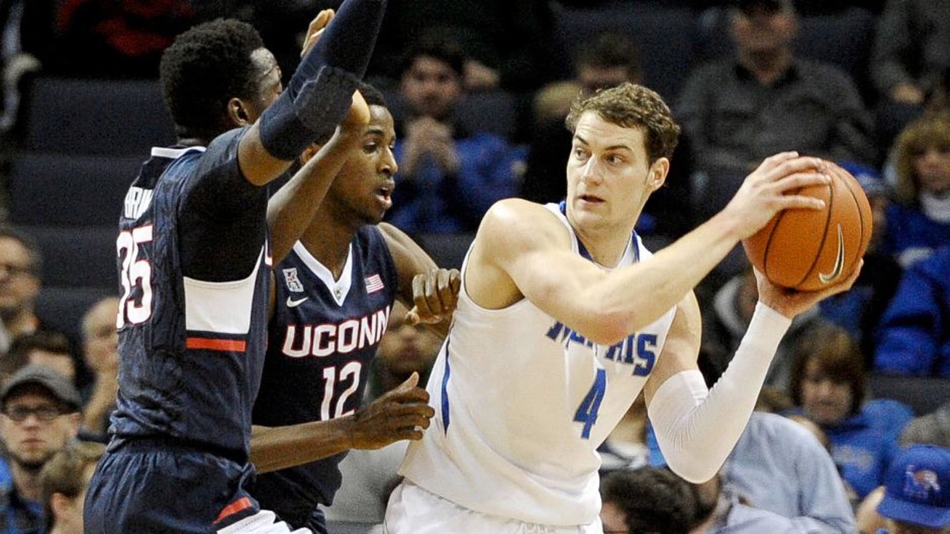 Feb 19, 2015; Memphis, TN, USA; Connecticut Huskies forward Kentan Facey (12) guards Memphis Tigers forward Austin Nichols (4) during the game at FedExForum. Mandatory Credit: Justin Ford-USA TODAY Sports