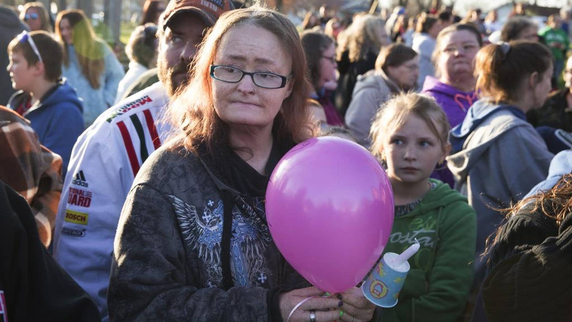 In this Friday, March 25, 2016 photo, Jessica Stewart holds a balloon during a candlelight prayer vigil for her daughter Shaylyn Ammerman at a park in Spencer, Ind. Several hundred people have gathered for the prayer vigil to mourn the loss of the girl found dead days after she went missing. (Jeremy Hogan/Bloomington Herald-Times via AP) MANDATORY CREDIT