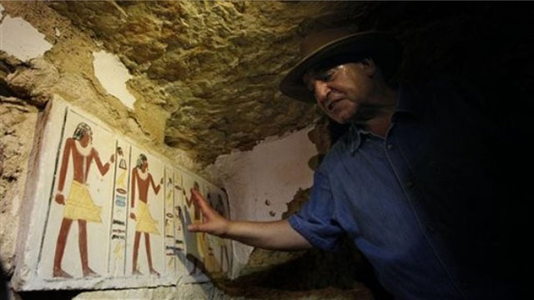 July 8: Egyptian Antiquities chief Zahi Hawass shows a false door to an unearthed 4,300-year-old tomb that belongs to Khonsu, the son of Shendwas. Both served as heads of the royal scribes during the Old Kingdom, in Saqqara near Cairo, Egypt.