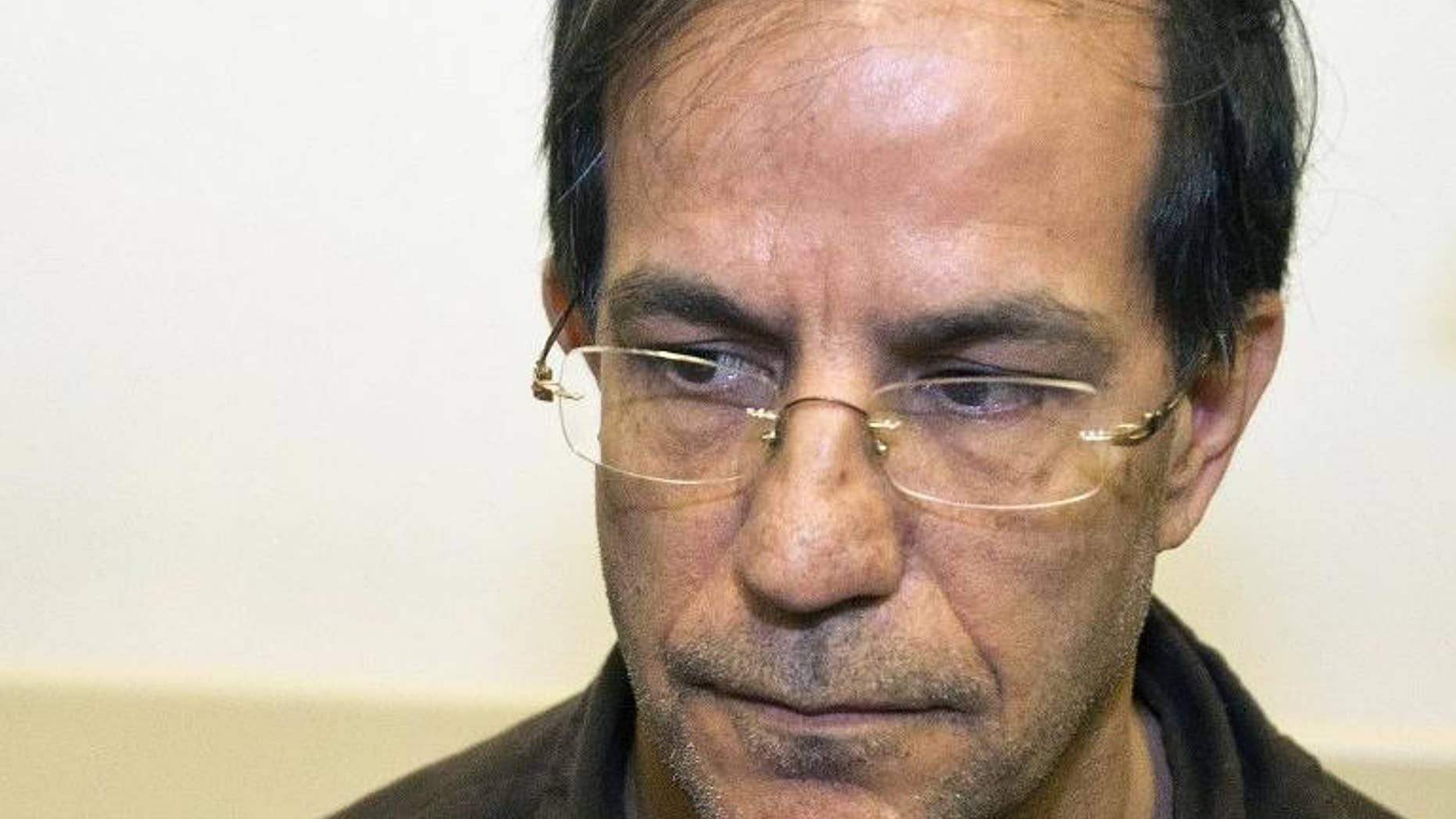 Ali Mansouri -- who was arrested at Ben Gurion Airport on suspicion of espionage -- sits at the Petah Tikva District Court on the first day of his trial, on September 30, 2013