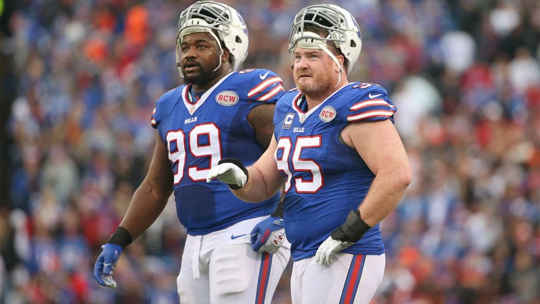 ORCHARD PARK, NY - NOVEMBER 30: Kyle Williams #95 of the Buffalo Bills and Marcell Dareus #99 look on during NFL game action against the Cleveland Browns at Ralph Wilson Stadium on November 30, 2014 in Orchard Park, New York. (Photo by Tom Szczerbowski/Getty Images)