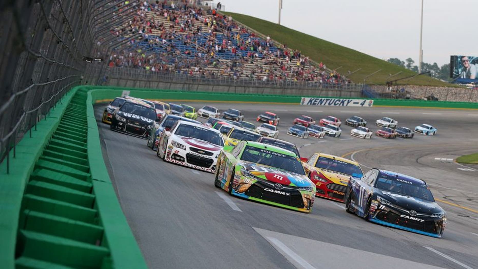 SPARTA, KY - JULY 11: Kyle Busch, driver of the #18 M&M's Crispy Toyota, and Denny Hamlin, driver of the #11 FedEx Office Toyota, lead the field on a restart during the NASCAR Sprint Cup Series Quaker State 400 presented by Advance Auto Parts at Kentucky Speedway on July 11, 2015 in Sparta, Kentucky. (Photo by Brian Lawdermilk/NASCAR via Getty Images)