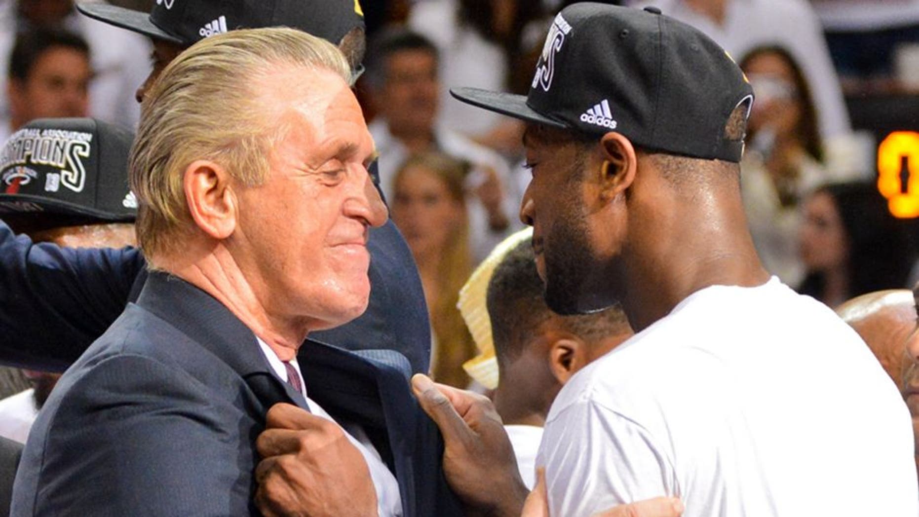 MIAMI, FL - JUNE 20: Dwyane Wade #3 and team President Pat Riley of the Miami Heat celebrate following their team's victory against the San Antonio Spurs in Game Seven of the 2013 NBA Finals on June 20, 2013 at American Airlines Arena in Miami, Florida. NOTE TO USER: User expressly acknowledges and agrees that, by downloading and or using this photograph, User is consenting to the terms and conditions of the Getty Images License Agreement. Mandatory Copyright Notice: Copyright 2013 NBAE (Photo by Jesse D. Garrabrant/NBAE via Getty Images)