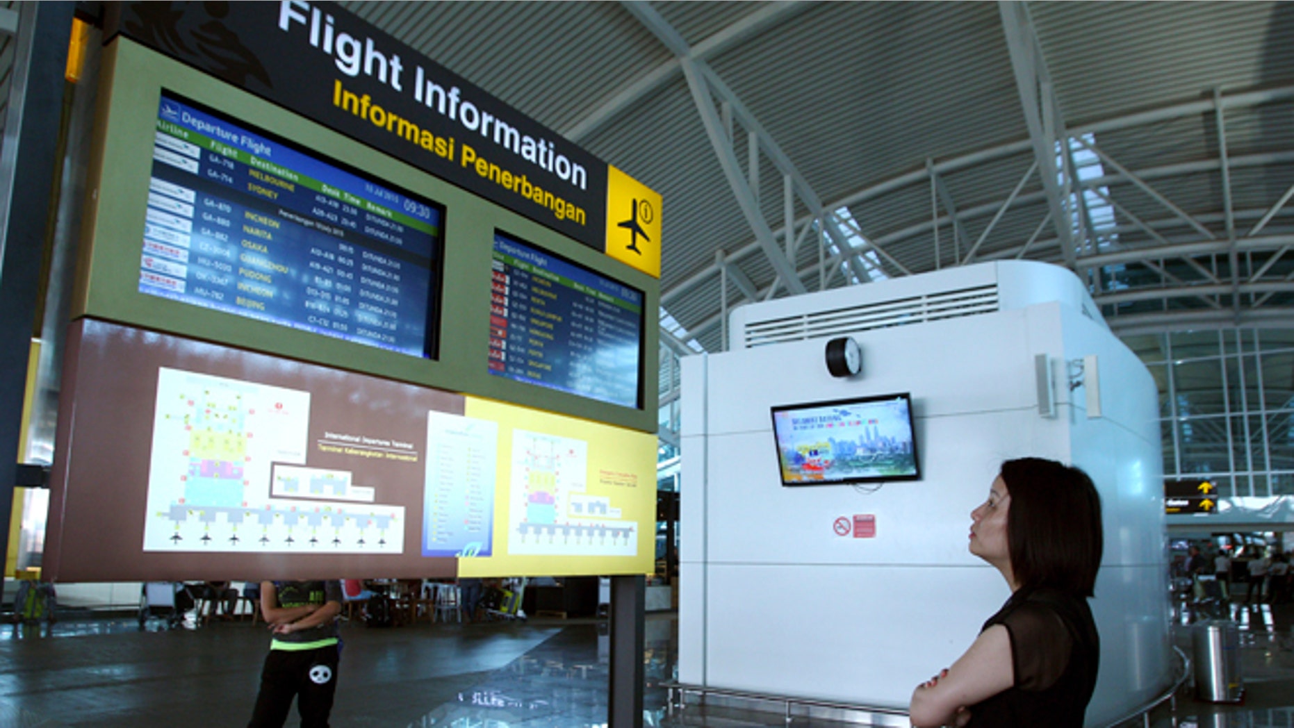 July 10, 2015: A traveler checks the status of flights at Bali's international airport, Indonesia.