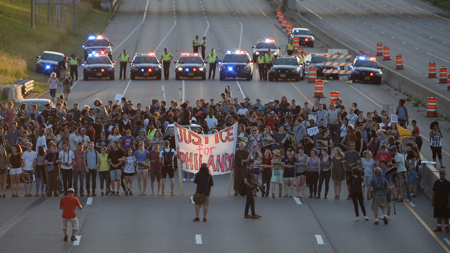 Marchers block part of Interstate 94 in St. Paul, Minn., Saturday, July 9, 2016, during a protest sparked by the recent police killings of black men in Minnesota and Louisiana.