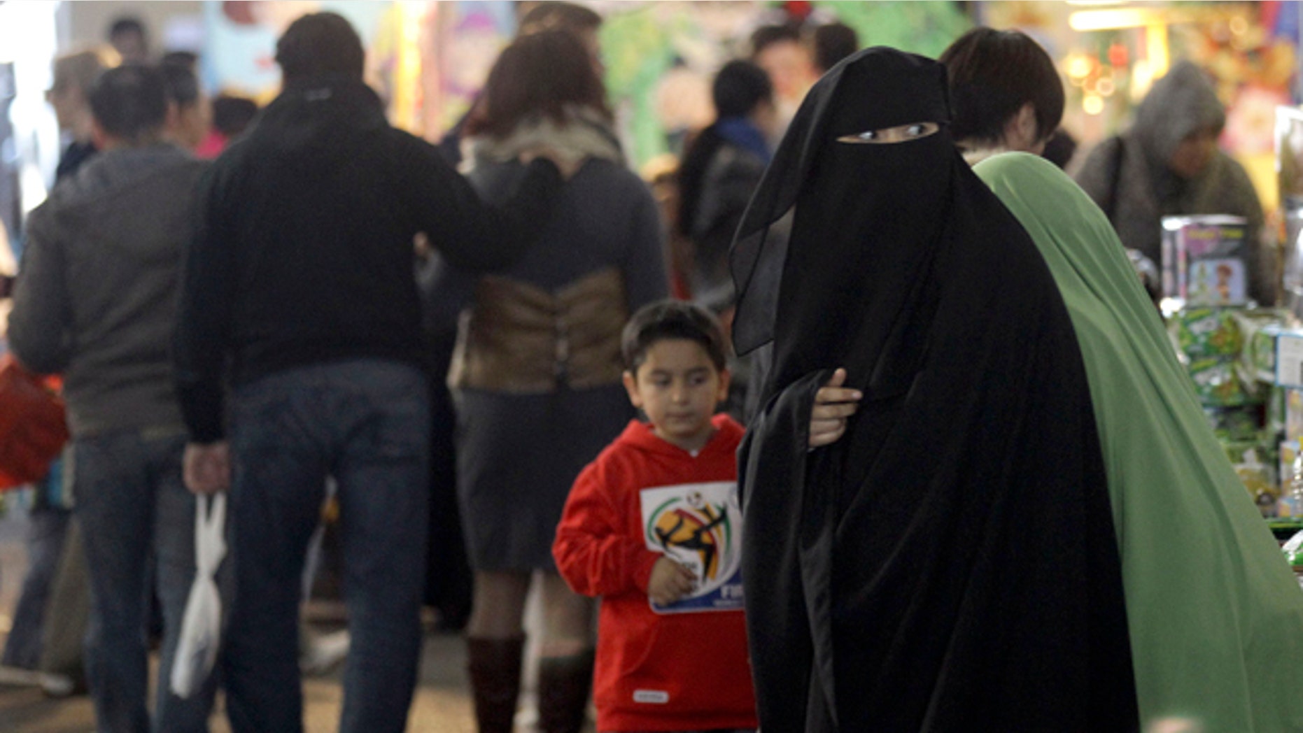 July 10: A Muslim woman wearing a burqa shops at a local market in Sydney.