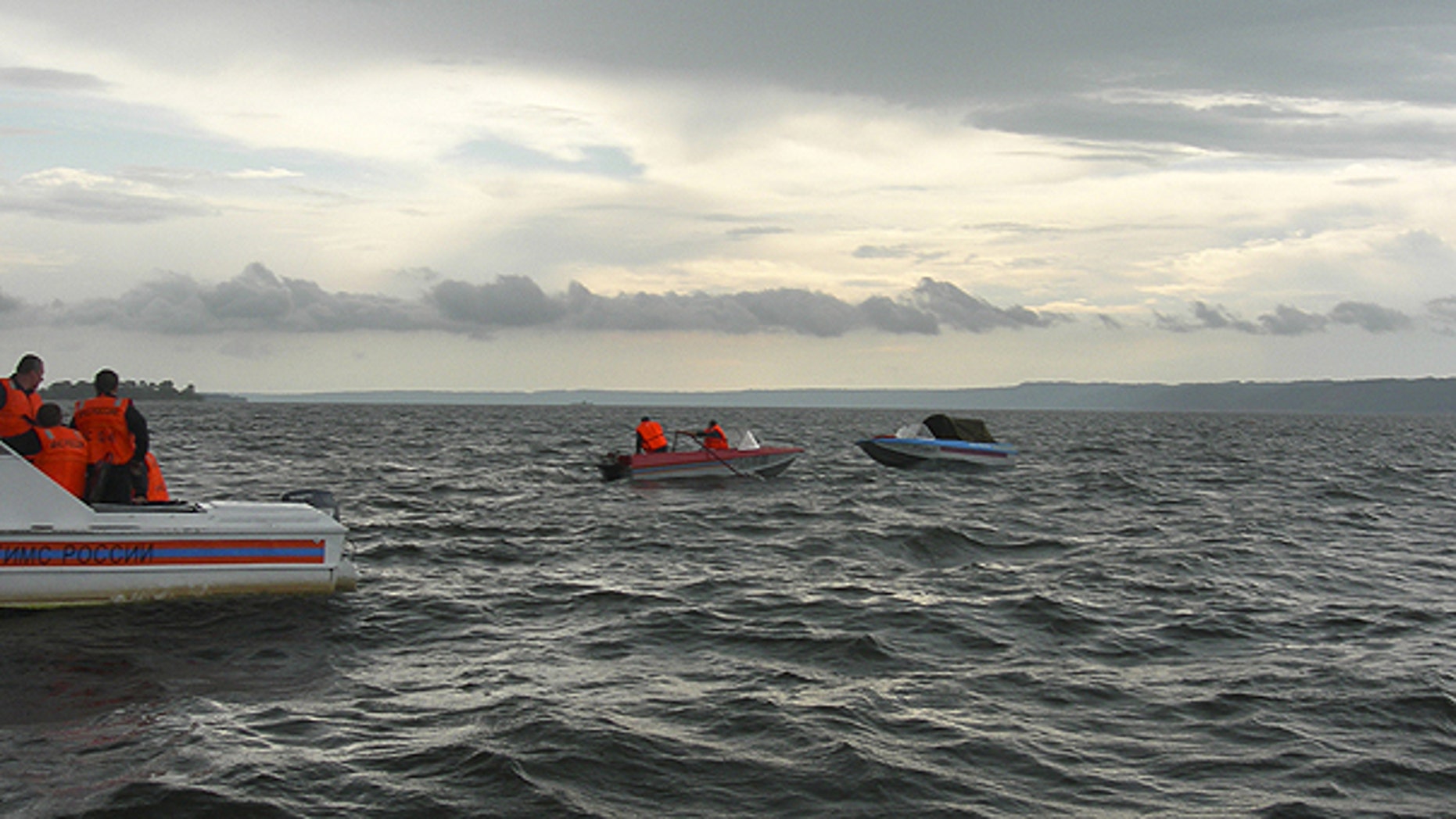 July 10: In this photo provided by Russia Emergency Situations Ministry press service, shows rescue boats trying to locate passengers of a tourist boat that sunk on the Volga River, in central Russia.