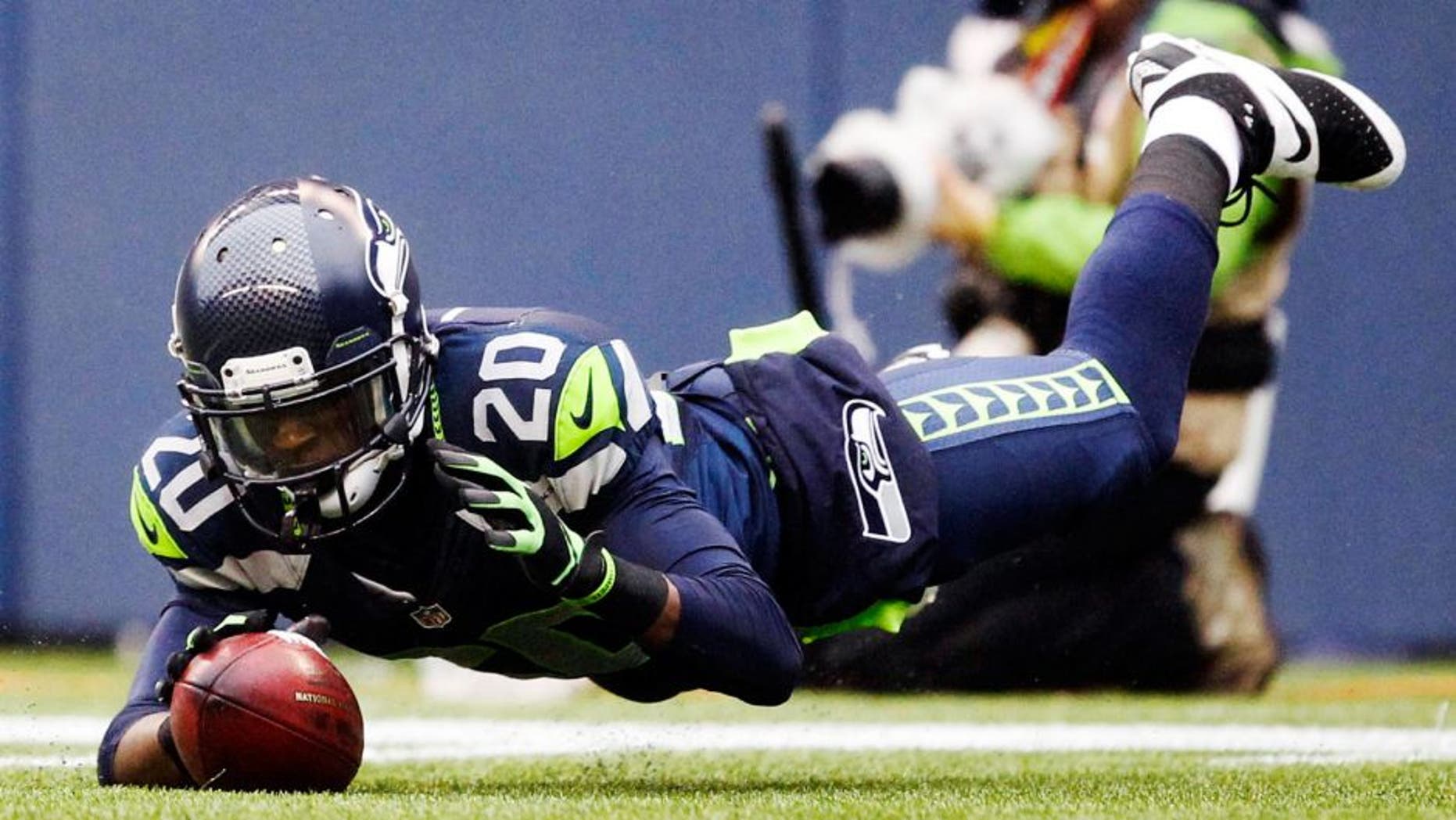 Dec 22, 2013; Seattle, WA, USA; Seattle Seahawks cornerback Jeremy Lane (20) downs a punt inside the five-yard line against the Arizona Cardinals during the second quarter at CenturyLink Field. Mandatory Credit: Joe Nicholson-USA TODAY Sports
