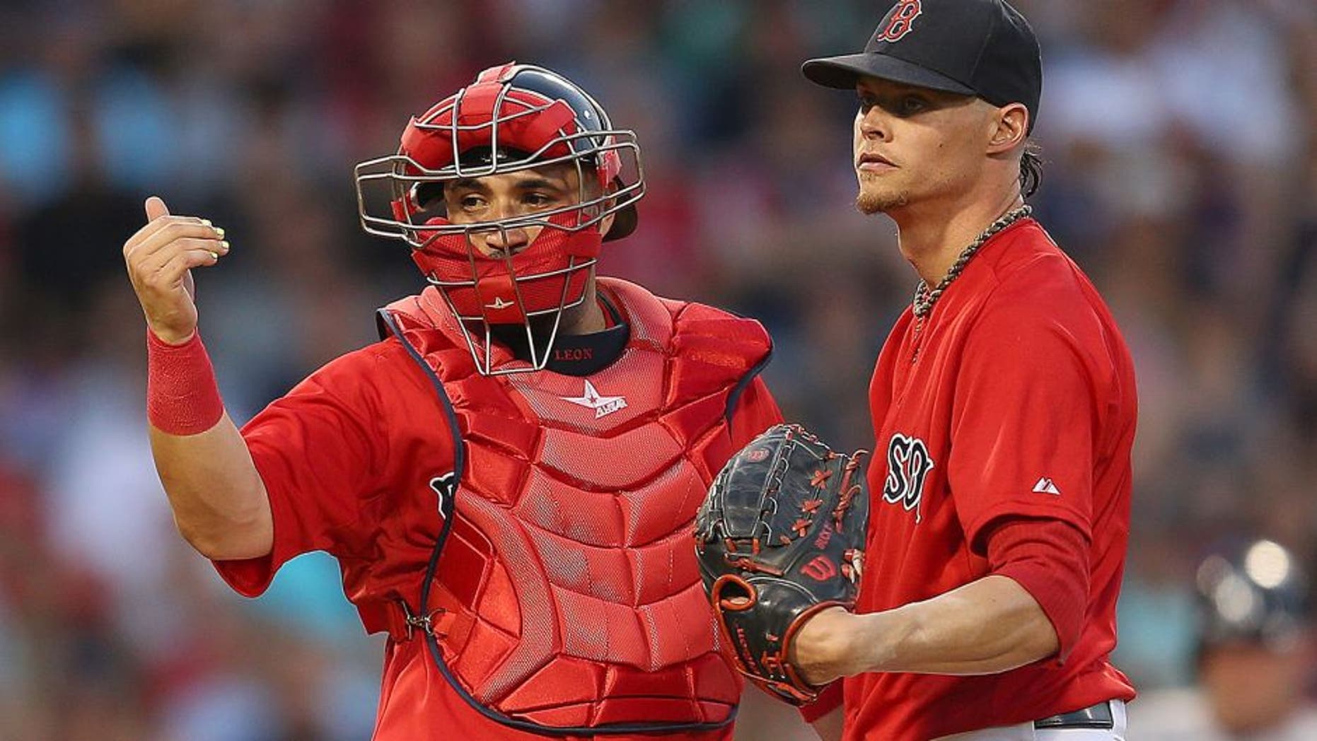 BOSTON, MA - JULY 10: Sandy Leon #3 of the Boston Red Sox signals to the dugout as Clay Buchholz #11 reacts on the mound in the fourth inning New York Yankees at Fenway Park on July 10, 2015 in Boston, Massachusetts. Buchholz left the game moments later. (Photo by Jim Rogash/Getty Images)