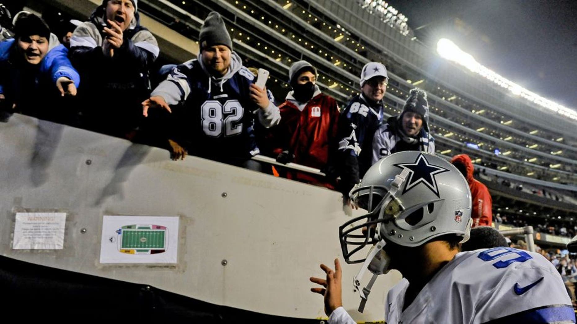 Dec 4, 2014; Chicago, IL, USA; Dallas Cowboys quarterback Tony Romo (9) greets fans after their game at Soldier Field. The Cowboys won 41-28. Mandatory Credit: Matt Marton-USA TODAY Sports