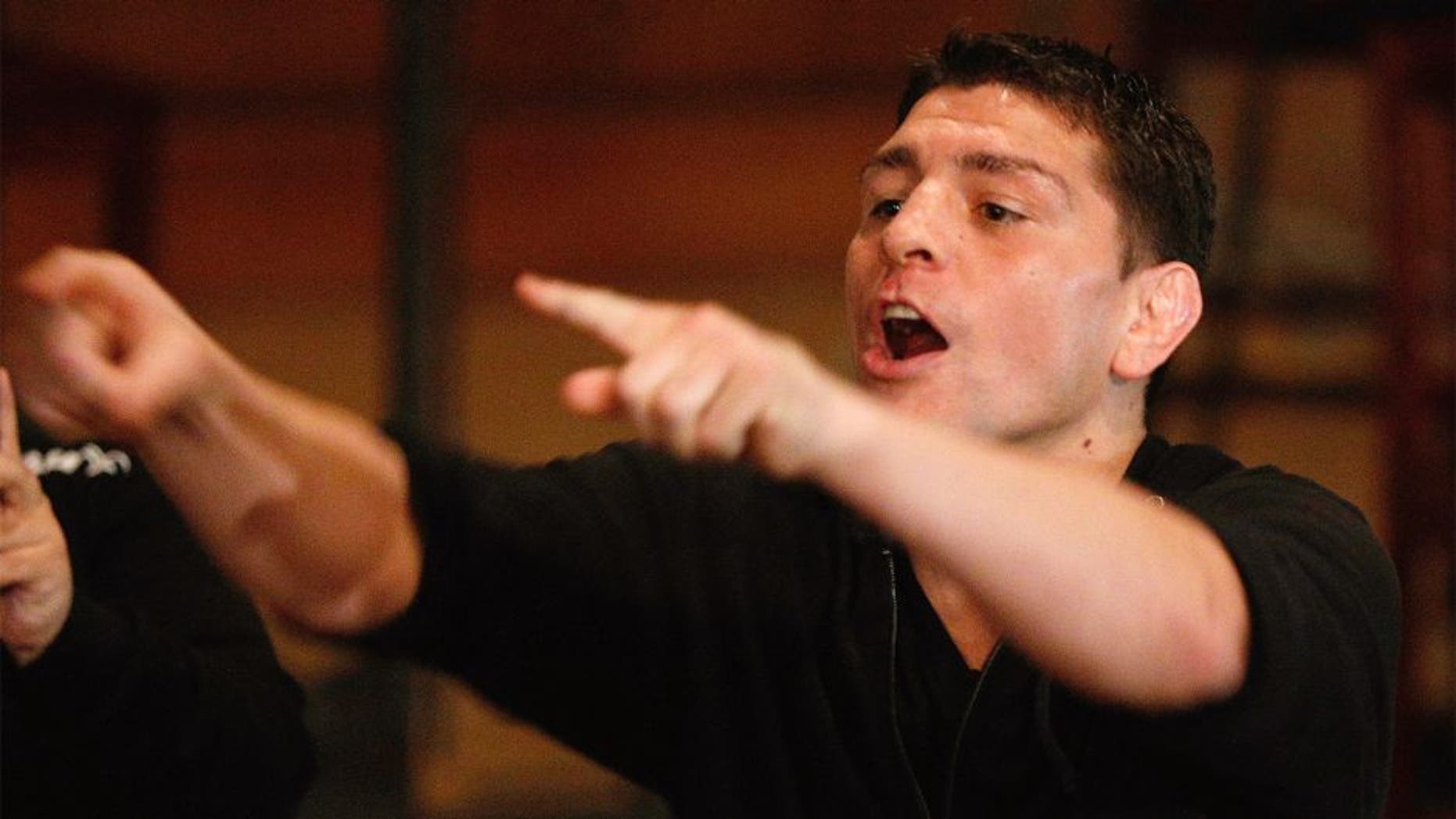 DALLAS, TX - MARCH 14: UFC welterweight star Nick Diaz heckles Johny Hendricks as he attempts to make weight during the UFC 171 official weigh-in at Gilley's Dallas on March 14, 2014 in Dallas, Texas. (Photo by Josh Hedges/Zuffa LLC/Zuffa LLC via Getty Images)