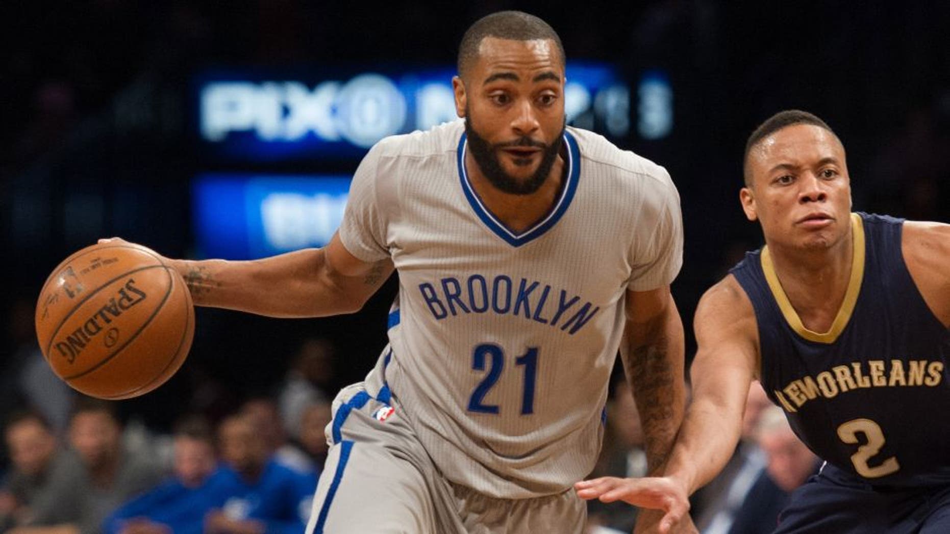 Apr 3, 2016; Brooklyn, NY, USA; Brooklyn Nets guard Wayne Ellington (21) dribbles around New Orleans Pelicans guard Tim Frazier (2) in the second half at Barclays Center. Pelicans defeat the Nets 106-87. Mandatory Credit: William Hauser-USA TODAY Sports