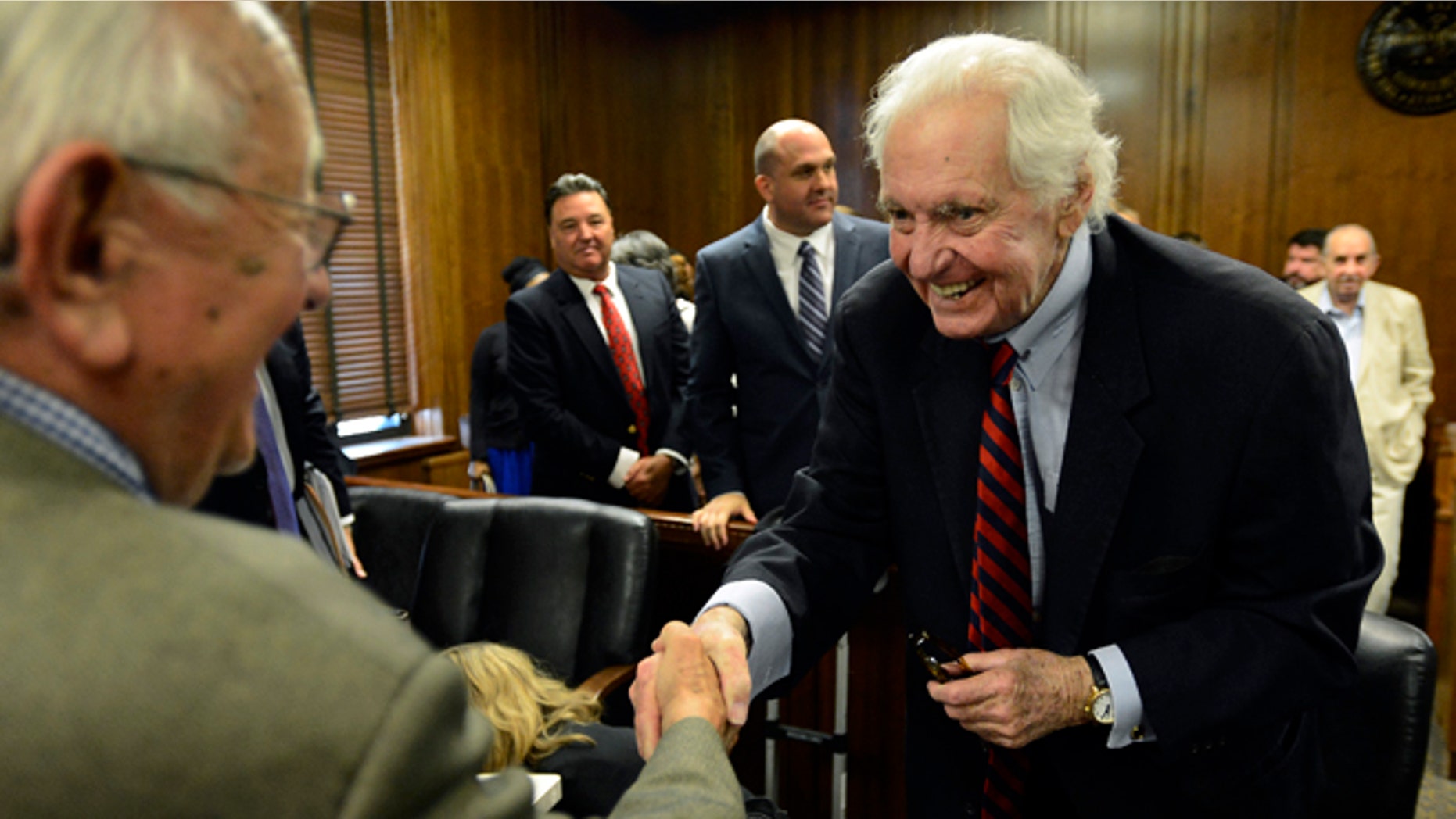 July 10, 2015: John Jay Hooker, right, is greeted after his hearing in Nashville, Tenn.