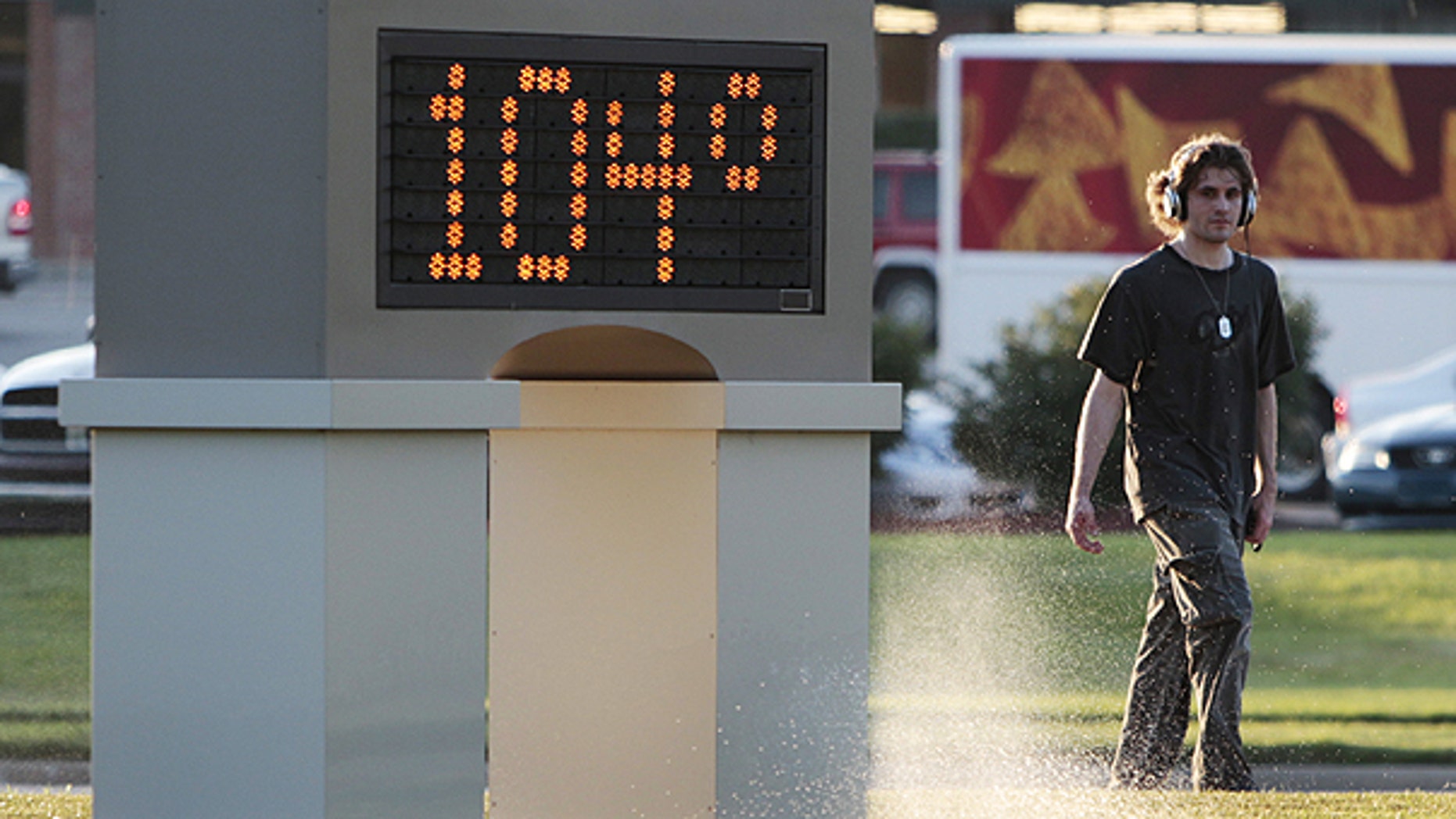 July 11: An unidentified pedestrian walks past a time and temperature sign in Lawrence, Kan.