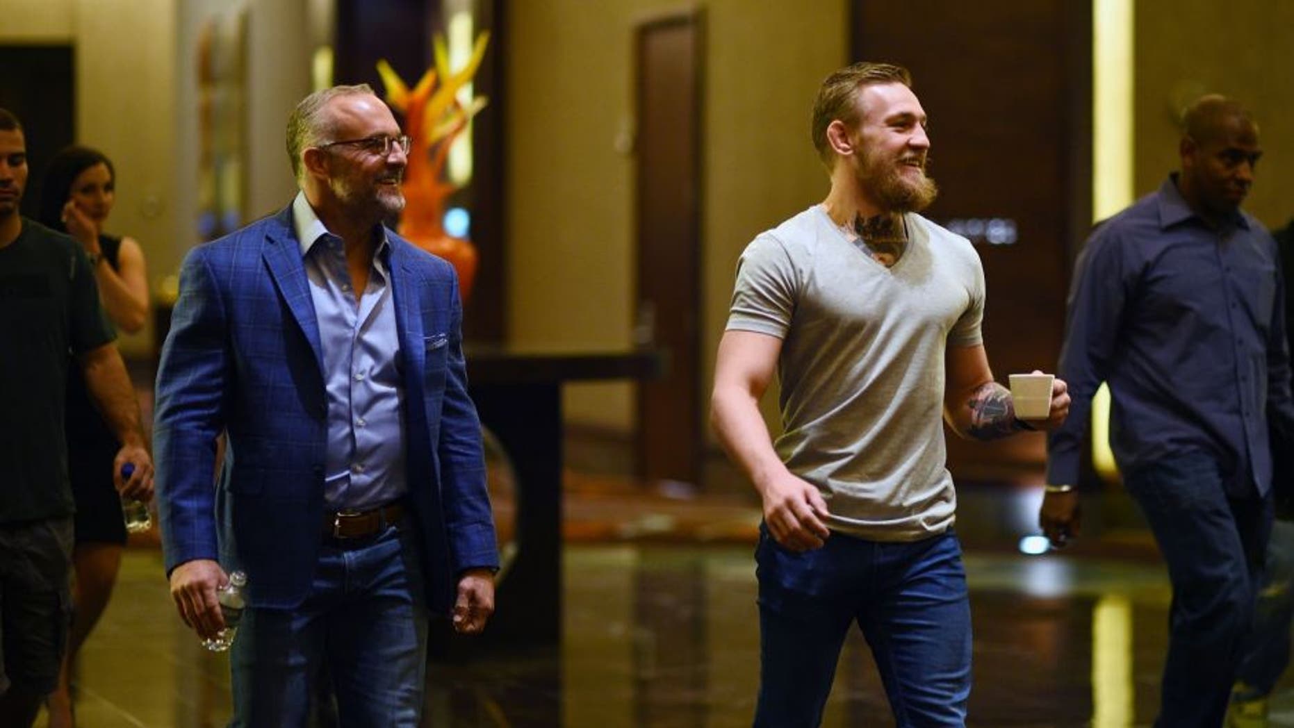 LAS VEGAS, NV - MARCH 23: UFC featherweight title challenger Conor McGregor of Ireland (R) walks with UFC CEO Lorenzo Fertitta during the UFC 189 World Championship Press Tour stop at the Red Rock Casino Resort on March 23, 2015 in Las Vegas, Nevada. (Photo by Jeff Bottari/Zuffa LLC/Zuffa LLC via Getty Images)