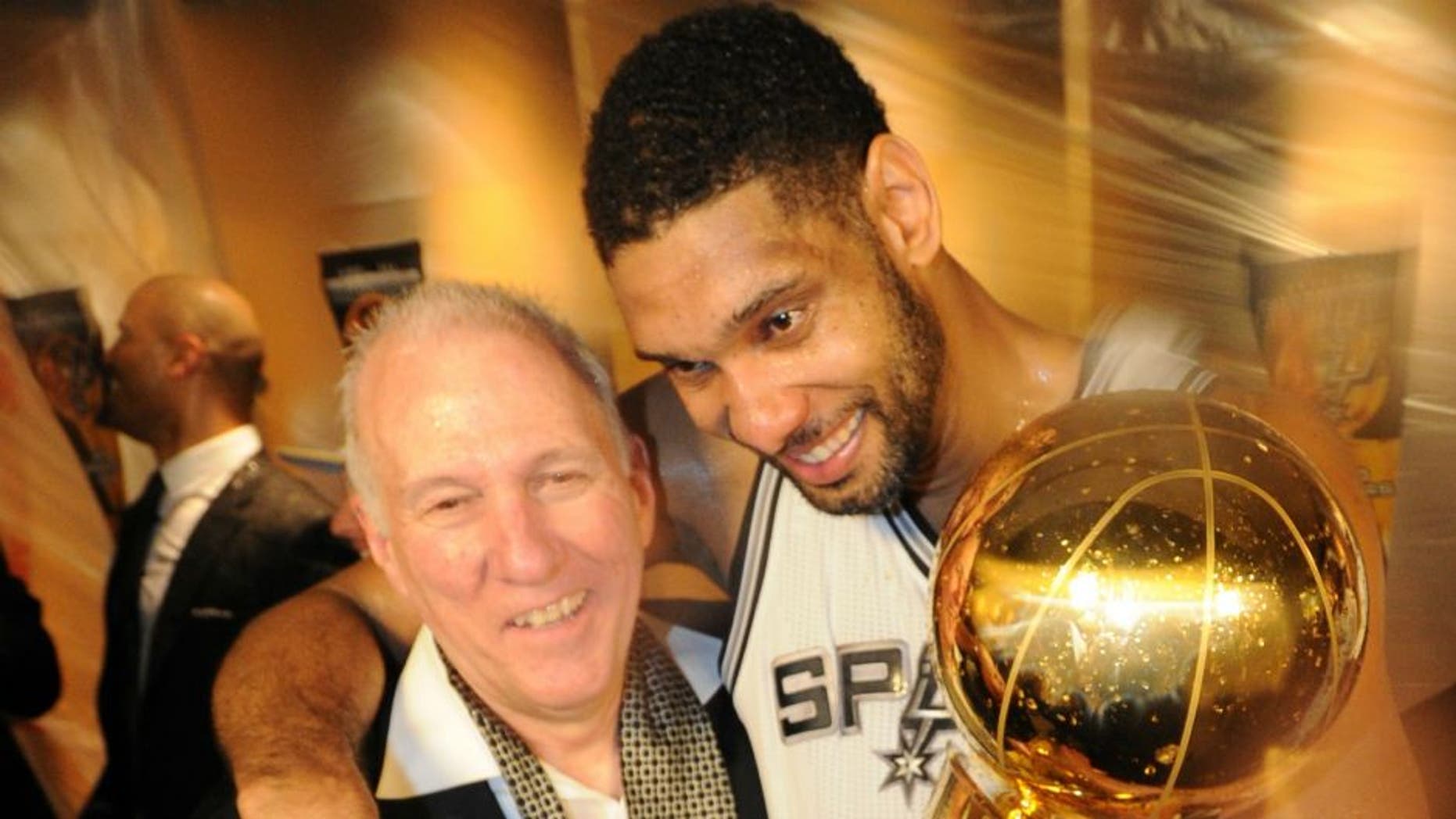 SAN ANTONIO, TX - JUNE 15: Tim Duncan #21 and Head Coach Gregg Popovich of the San Antonio Spurs celebrates after winning the NBA Championship against the Miami Heat during Game Five of the 2014 NBA Finals between the Miami Heat and San Antonio Spurs at AT&T Center on June 15, 2014 in San Antonio, Texas. NOTE TO USER: User expressly acknowledges and agrees that, by downloading and/or using this photograph, user is consenting to the terms and conditions of the Getty Images License Agreement. Mandatory Copyright Notice: Copyright 2014 NBAE (Photo by Andrew D Bernstein/NBAE via Getty Images)