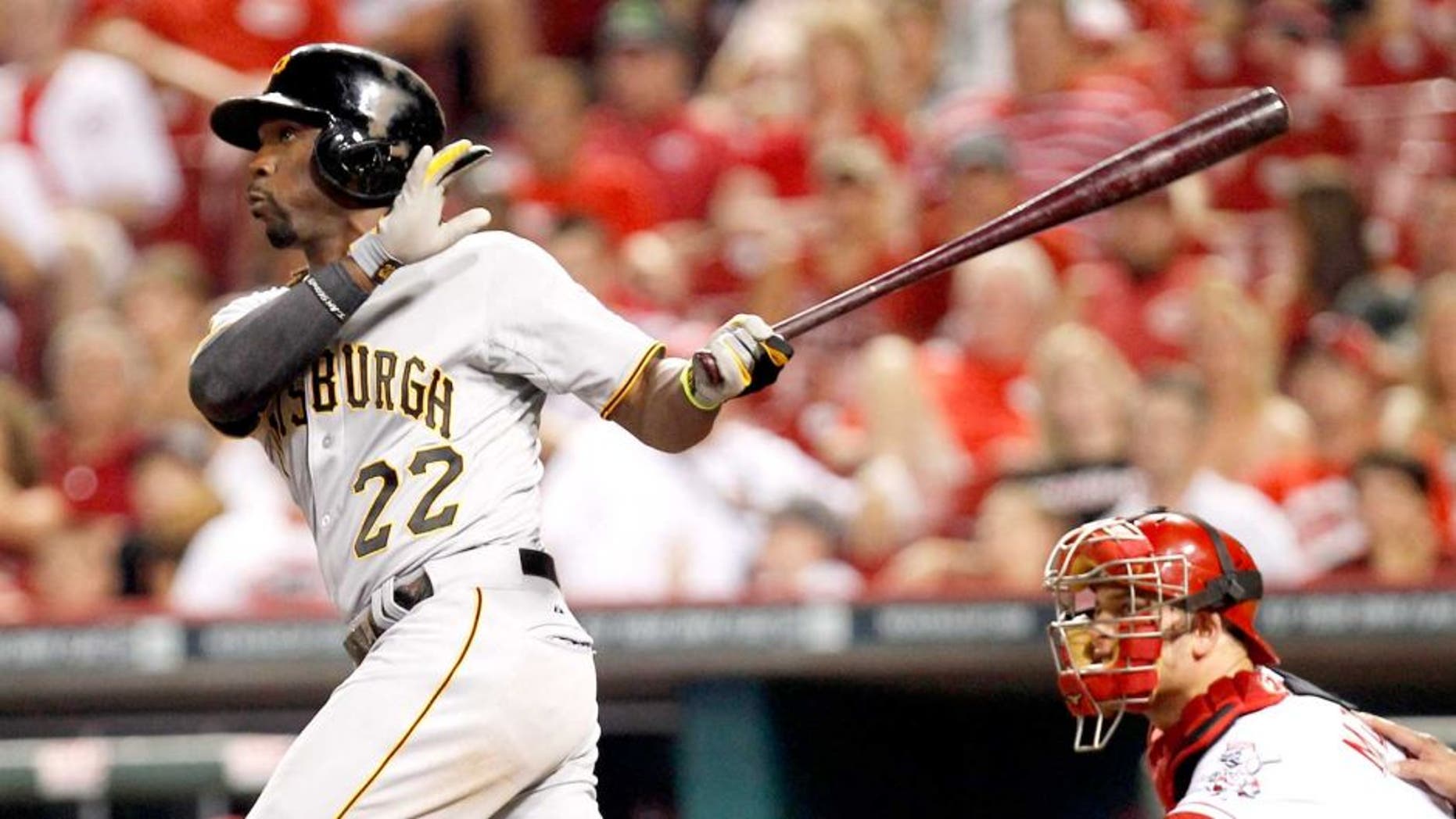 Jul 12, 2014; Cincinnati, OH, USA; Pittsburgh Pirates center fielder Andrew McCutchen (22) hits the game winning home run during the eleventh inning against the Cincinnati Reds at Great American Ball Park. The Pirates defeated the Reds 6-5. Mandatory Credit: Frank Victores-USA TODAY Sports
