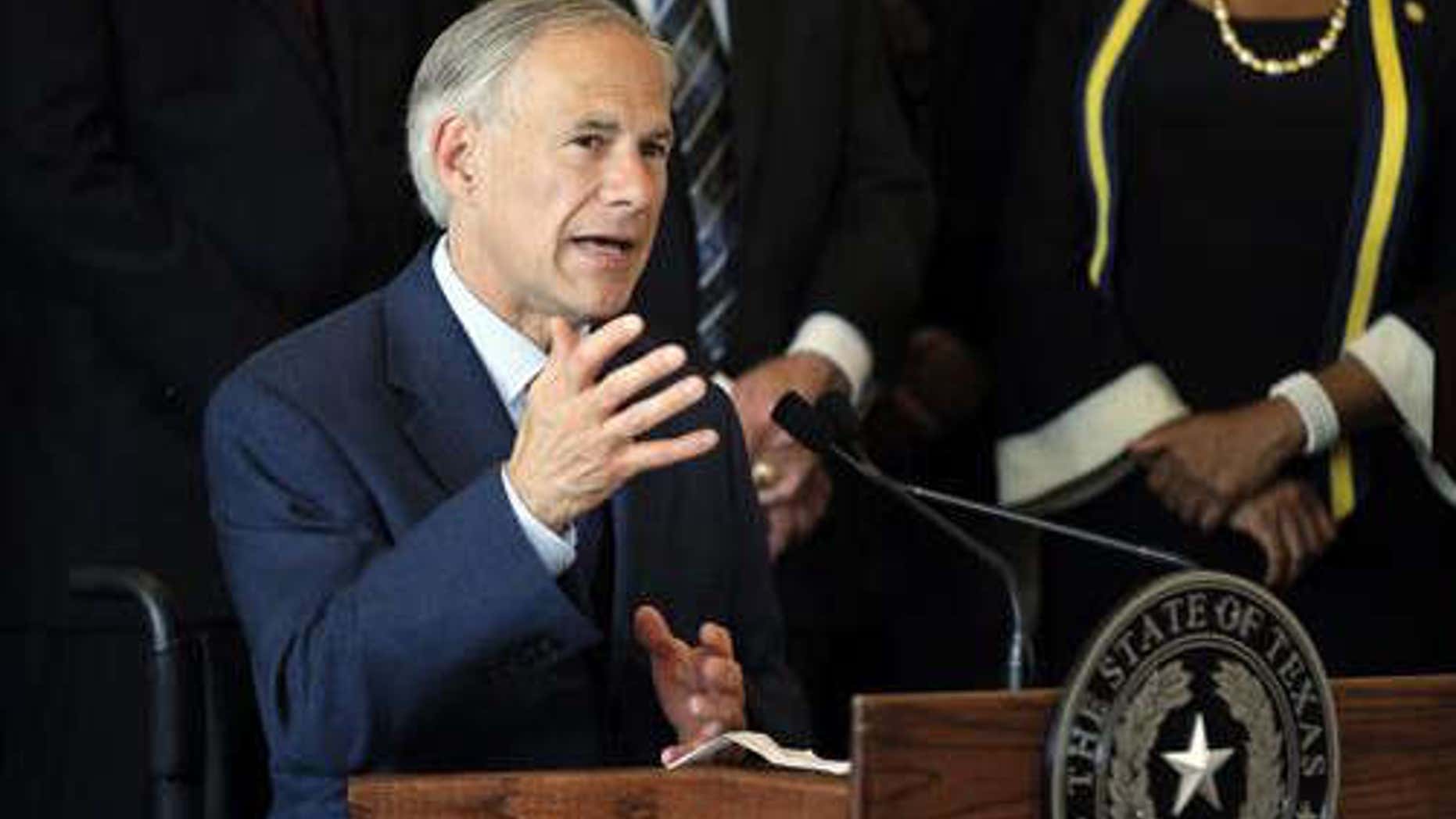 FILE - In this Friday, July 8, 2016 file photo, Texas Gov. Greg Abbott, right, responds to questions about the police shootings during a news conference at City Hall in Dallas.