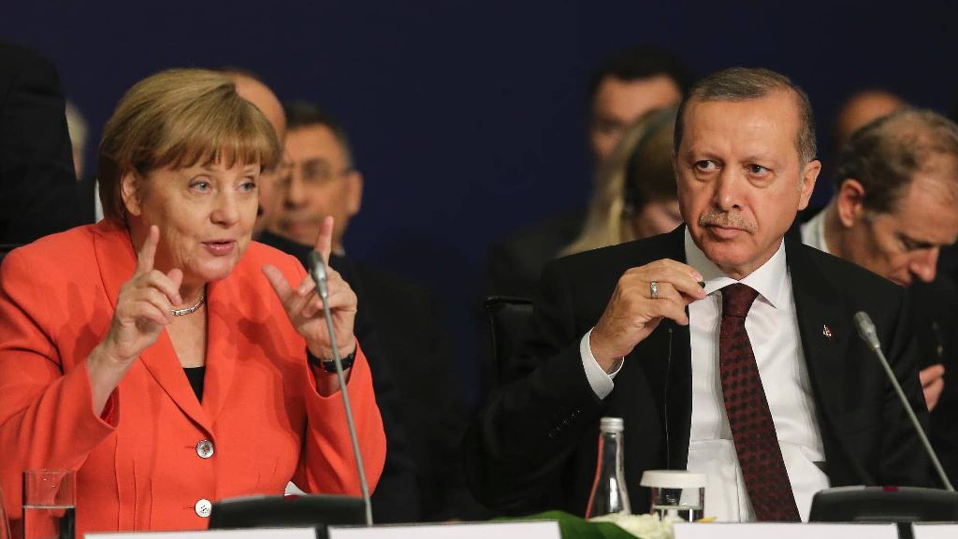 German Chancellor Angela Merkel, left, talks as Turkey's President Recep Tayyip Erdogan listens during a roundtable meeting on "Political Leadership to Prevent and End Conflicts" at the World Humanitarian Summit in Istanbul, Monday, May 23, 2016. World leaders and representatives of humanitarian organisations from across the globe converge in Istanbul on May 23-24, 2016 for the first World Humanitarian Summit, focused on how to reform a system many judge broken. (Salih Zeki Fazlioglu/Anadolu, Pool Photo via AP)