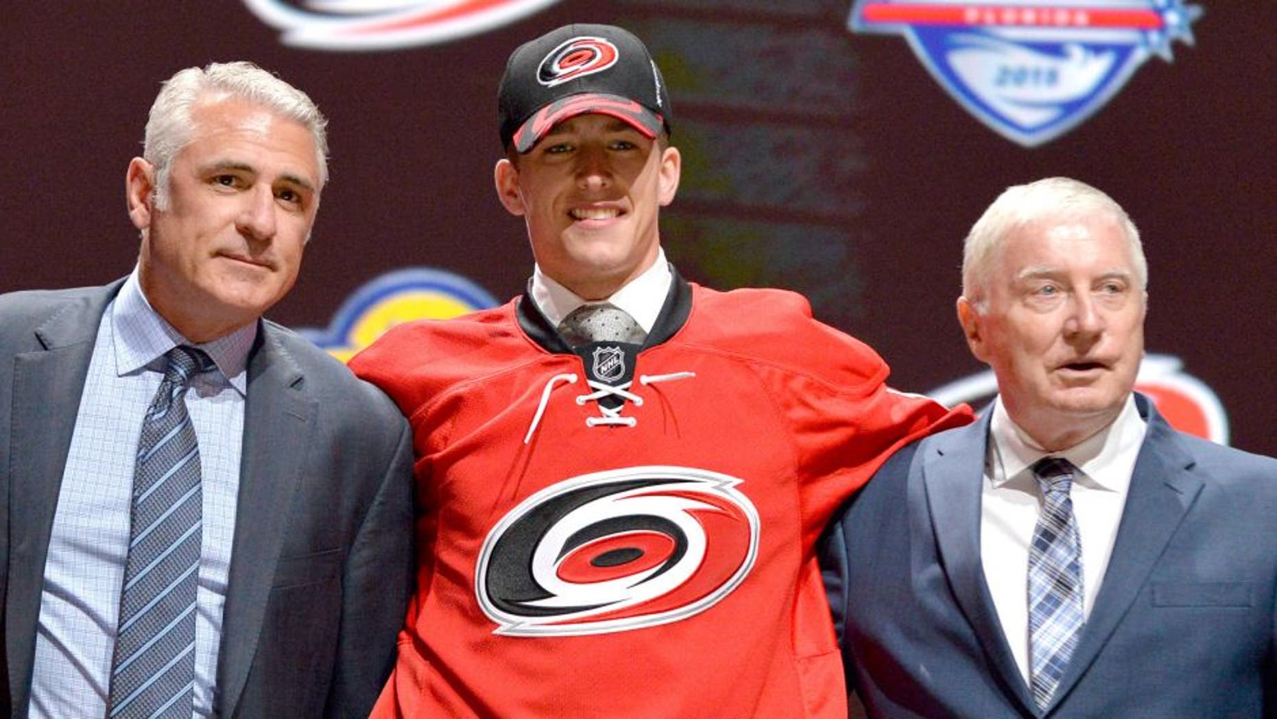 Jun 26, 2015; Sunrise, FL, USA; Noah Hanifin poses with team executives after being selected as the number five overall pick to the Carolina Hurricanes in the first round of the 2015 NHL Draft at BB&T Center. Mandatory Credit: Steve Mitchell-USA TODAY Sports