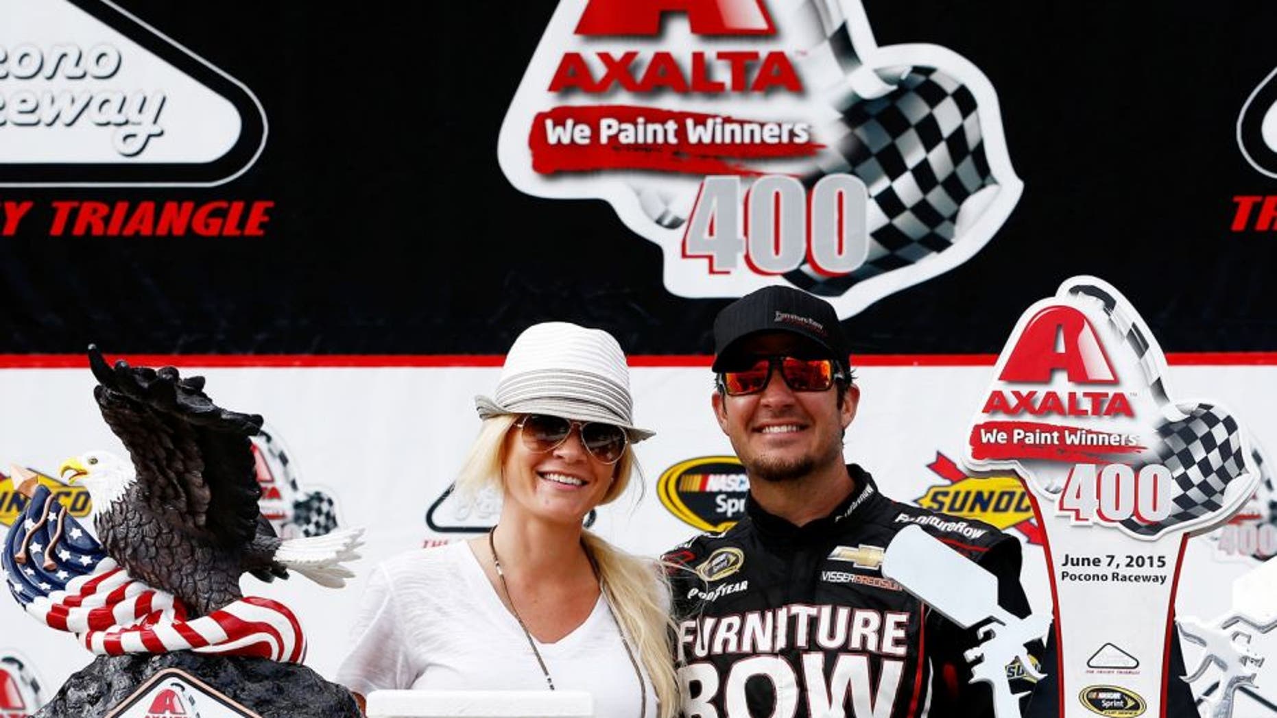 LONG POND, PA - JUNE 07: Martin Truex Jr., driver of the #78 Furniture Row/Visser Precision Chevrolet, right, and his girlfriend, Sherry Pollex, pose in Victory Lane after Truex Jr. won the NASCAR Sprint Cup Series Axalta 'We Paint Winners' 400 at Pocono Raceway on June 7, 2015 in Long Pond, Pennsylvania. (Photo by Jeff Zelevansky/NASCAR via Getty Images)