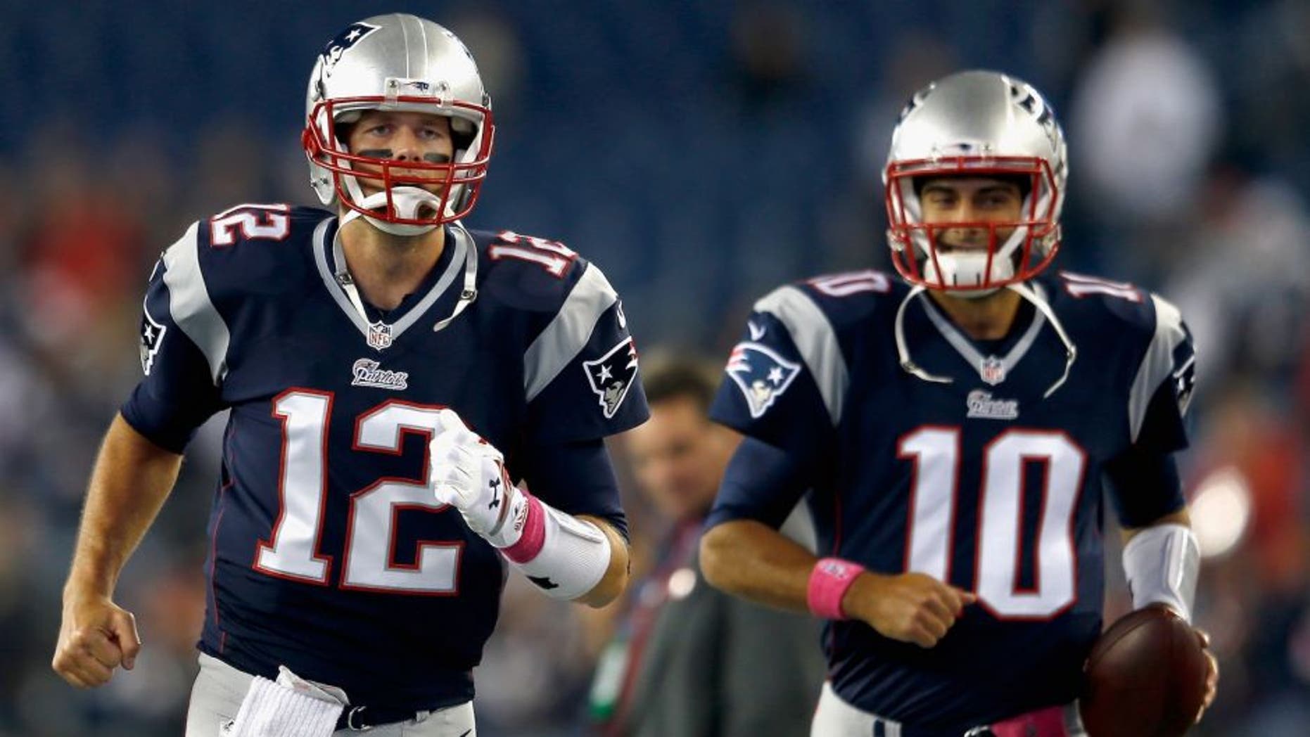 FOXBORO, MA - OCTOBER 05: Tom Brady #12 and Jimmy Garoppolo #10 of the New England Patriots warm up before a game against the Cincinnati Bengals at Gillette Stadium on October 5, 2014 in Foxboro, Massachusetts. (Photo by Jim Rogash/Getty Images)