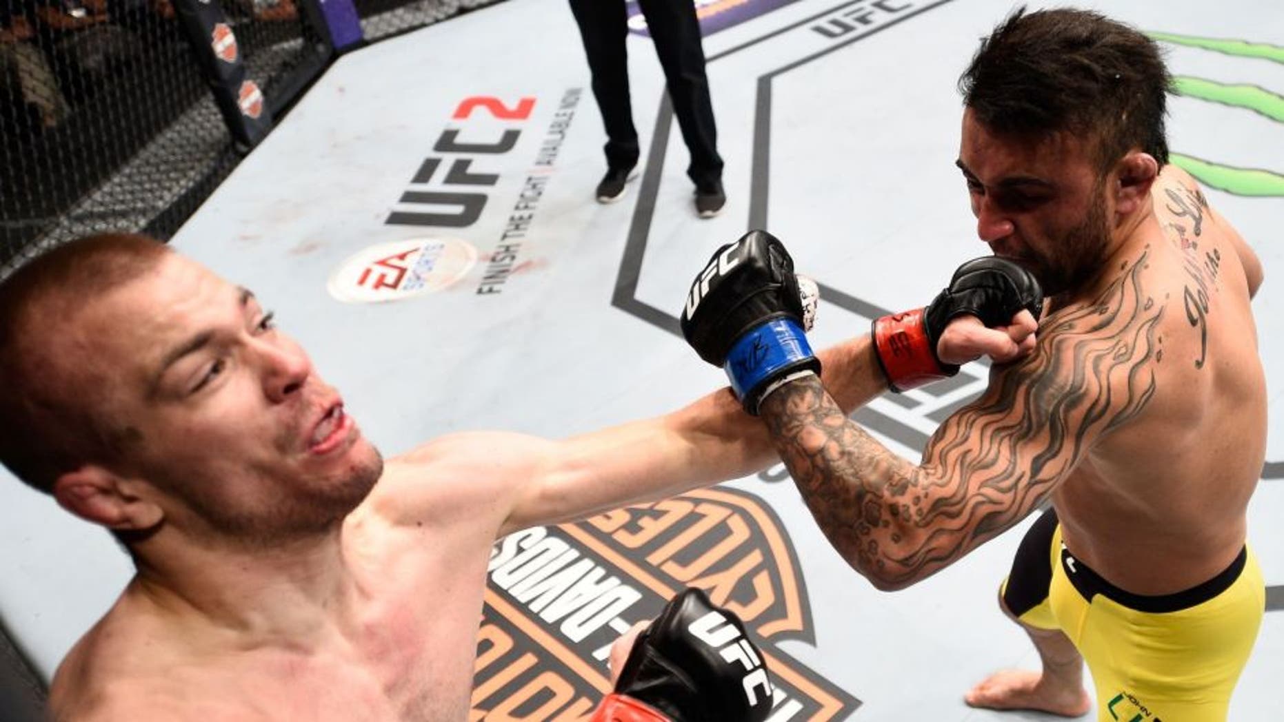 SIOUX FALLS, SD - JULY 13: (R-L) John Lineker punches Michael McDonald in their bantamweight bout during the UFC Fight Night event on July 13, 2016 at Denny Sanford Premier Center in Sioux Falls, South Dakota. (Photo by Jeff Bottari/Zuffa LLC/Zuffa LLC via Getty Images)