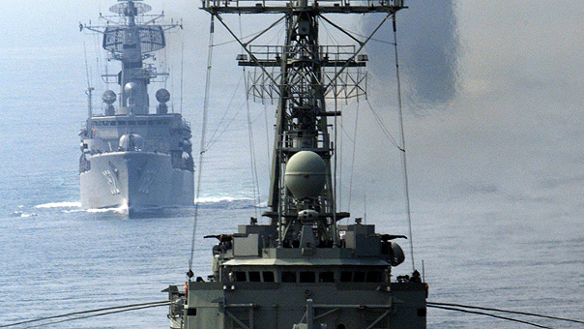 July 7: In this photo released by U.S. Navy, Royal Australian Navy ship HMAS Darwin (FFG 04), foreground, Indonesian ship KRI Slamet Riyadi (352), middle, and USS Cowpens (CG 63) steam in formation in Indian Ocean after transiting from the Java Sea through the Sunda Strait.