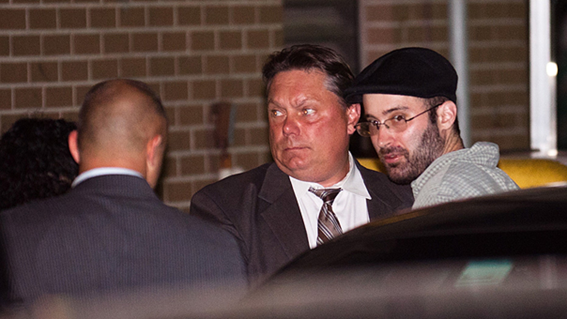July 14: Levi Aron, right, the suspect accused killing and dismembering 8-year-old Brooklyn boy Leiby Kletzy, is led into the 67th Precinct by police in Brooklyn.