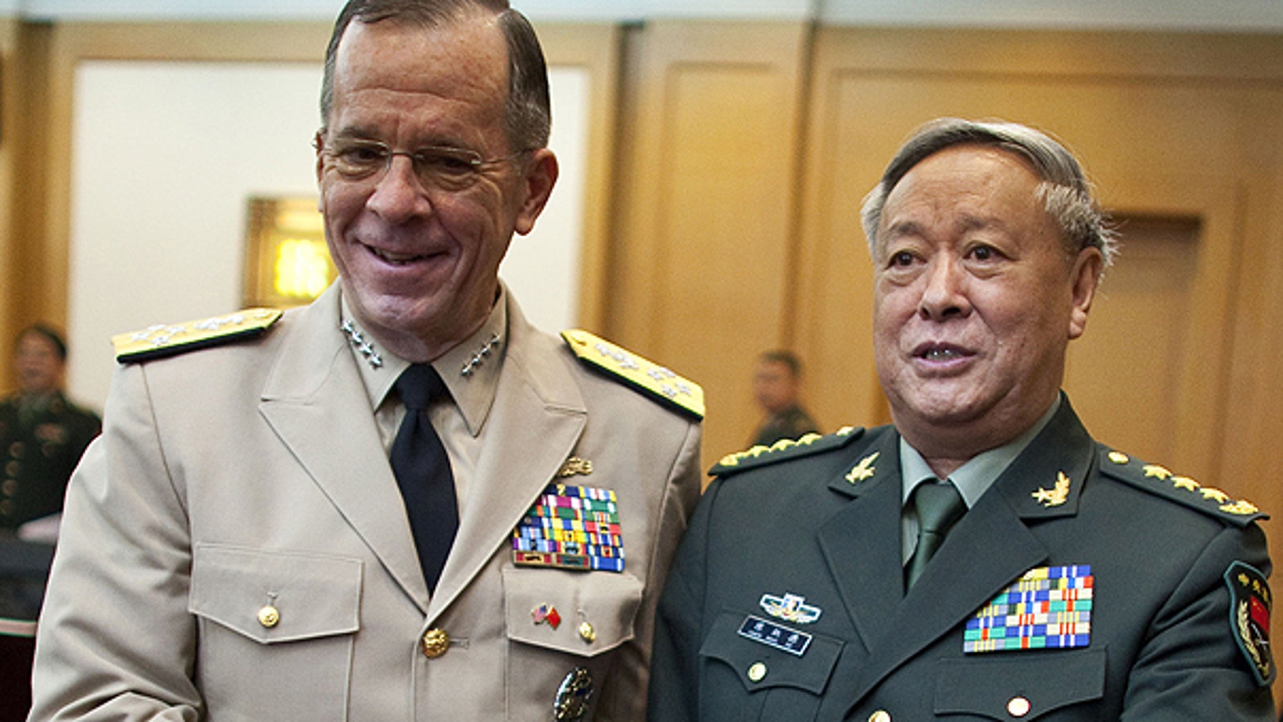 July 11: U.S. Adm. Mike Mullen, left, chairman of the Joint Chiefs of Staff, shakes hands with Gen. Chen Bingde, chief of the General Staff of the Chinese People's Liberation Army, before their meeting at the Bayi Building in Beijing, China.