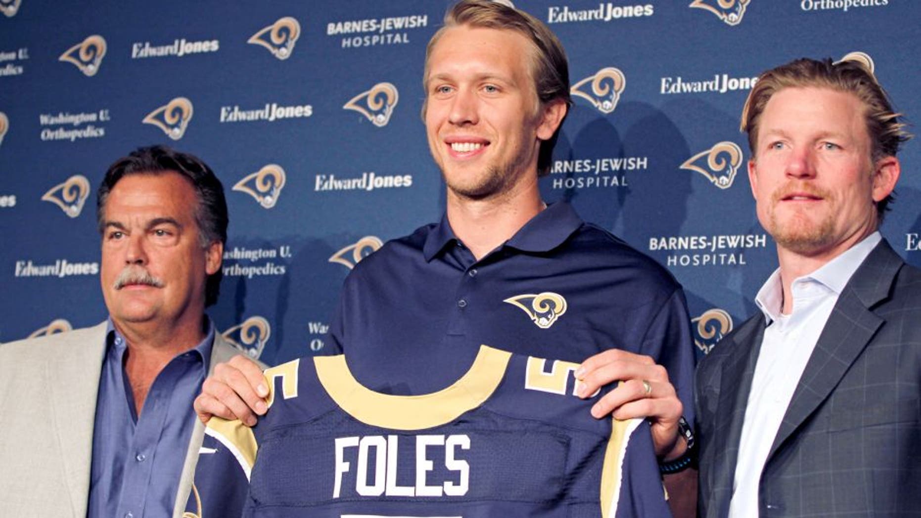 Mar 13, 2015; St. Louis, MO, USA; St. Louis Rams quarterback Nick Foles (center) is introduced to the media at Rams Park. Foles is joined by Rams head coach Jeff Fisher (left) and general manager Les Snead (right). Mandatory Credit: Billy Hurst-USA TODAY Sports