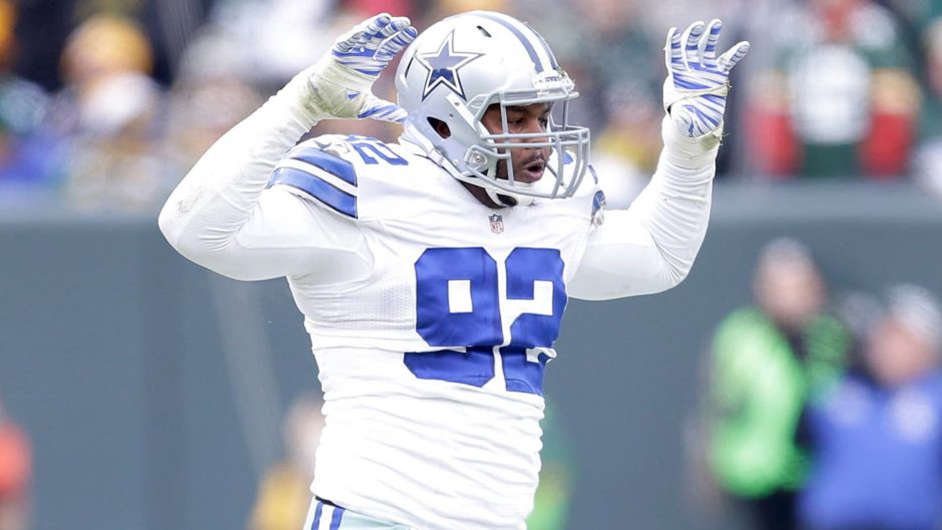GREEN BAY, WI - JANUARY 11: Jeremy Mincey #92 of the Dallas Cowboys reacts after sacking quarterback Aaron Rodgers #12 of the Green Bay Packers (not pictured) during the 2015 NFC Divisional Playoff game at Lambeau Field on January 11, 2015 in Green Bay, Wisconsin. (Photo by Mike McGinnis/Getty Images)