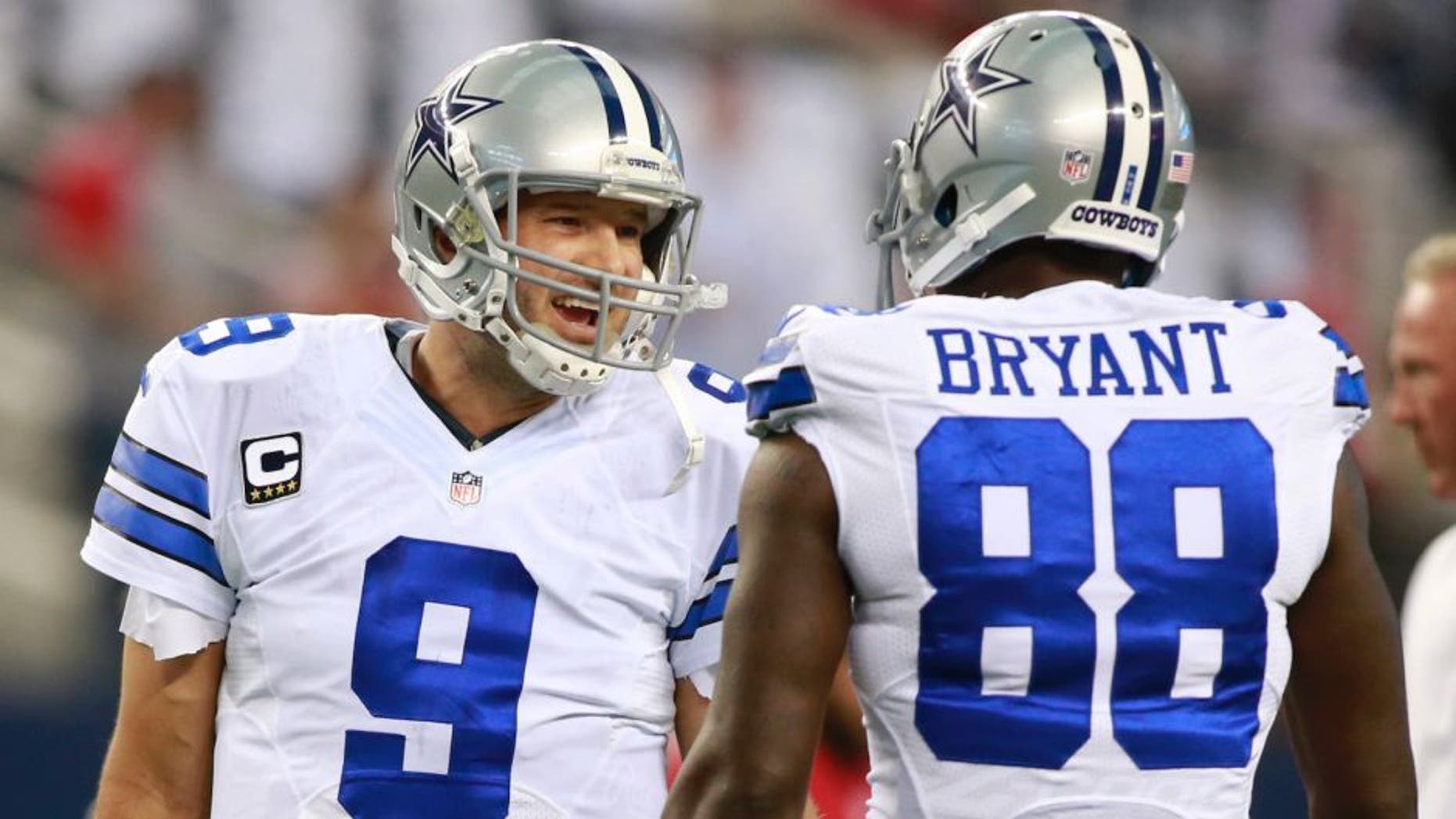 Sep 7, 2014; Arlington, TX, USA; Dallas Cowboys quarterback Tony Romo (9) talks with wide receiver Dez Bryant (88) before the game against the San Francisco 49ers at AT&T Stadium. Mandatory Credit: Tim Heitman-USA TODAY Sports